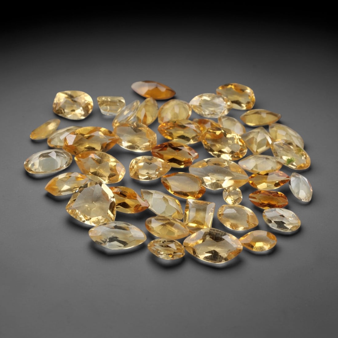 5.02 Carats Golden Yellow Citrine Parcel - Natural Brazilian Stones, 96XN: This luminous parcel of faceted citrine gemstones, weighing a total of 5.02 carats with individual dimensions ranging from 2.1 to 4.5 mm, radiates a rich spectrum of golden yellow hues, from pale, sun