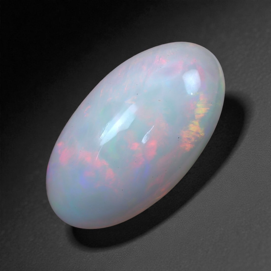 4.22 Carats Roselight Welo Opal - Natural Ethiopian Gemstone 16.5x9.2x5.6mm, 25XH: Soft clouds of pink, lavender, and citrus yellow shimmer within this polished Welo opal, revealing a dreamy internal fire that glows beneath a smooth, milky surface. The play-of-color unfolds in gentl