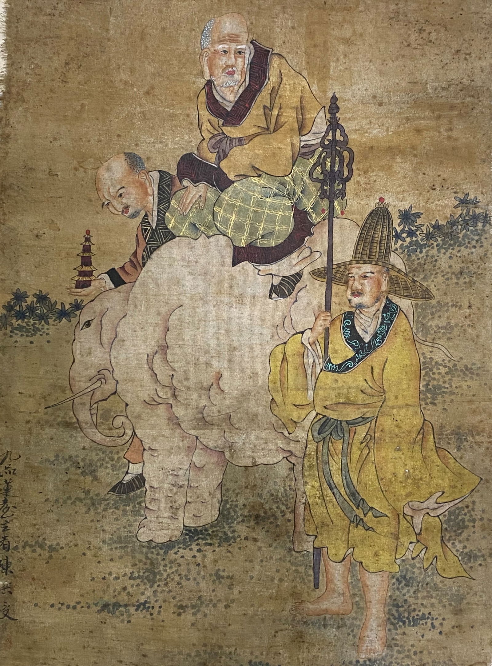 A Chinese Ink and Color Art Print, Monks with a White Elephant, 20th Century, 20FV: Printed on an aged, textured fabric or linen ground, the composition depicts three figures in a narrative scene. A senior monk in golden-yellow robes with a checkered undergarment rides a large white