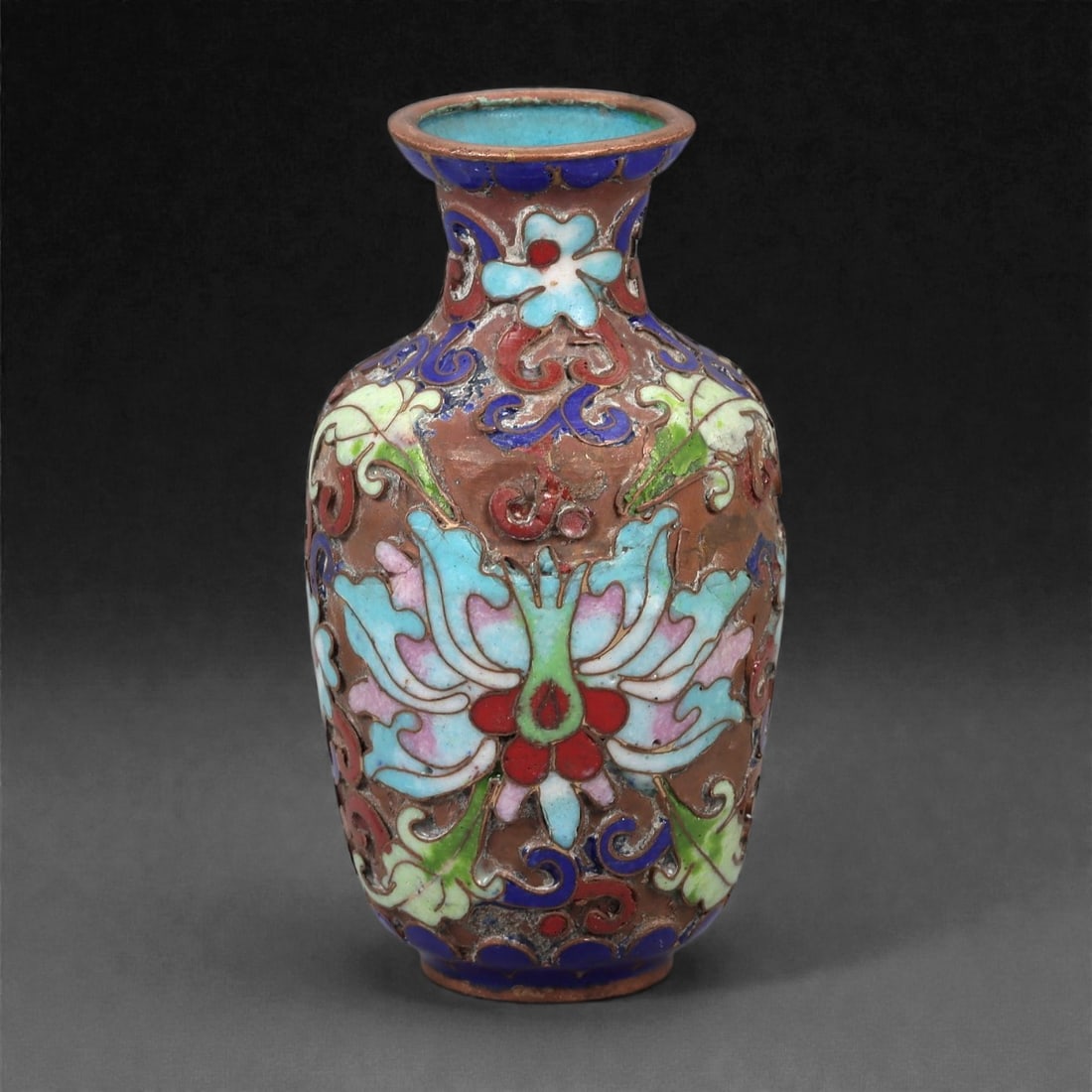 A Chinese Cloisonne Enamel Vase, 20th Century, 2FJ: The vessel is formed from a copper body with applied cloisonne wirework filled with opaque enamel. It is potted with a small ovoid body rising from a narrow foot to a short waisted neck with a flared