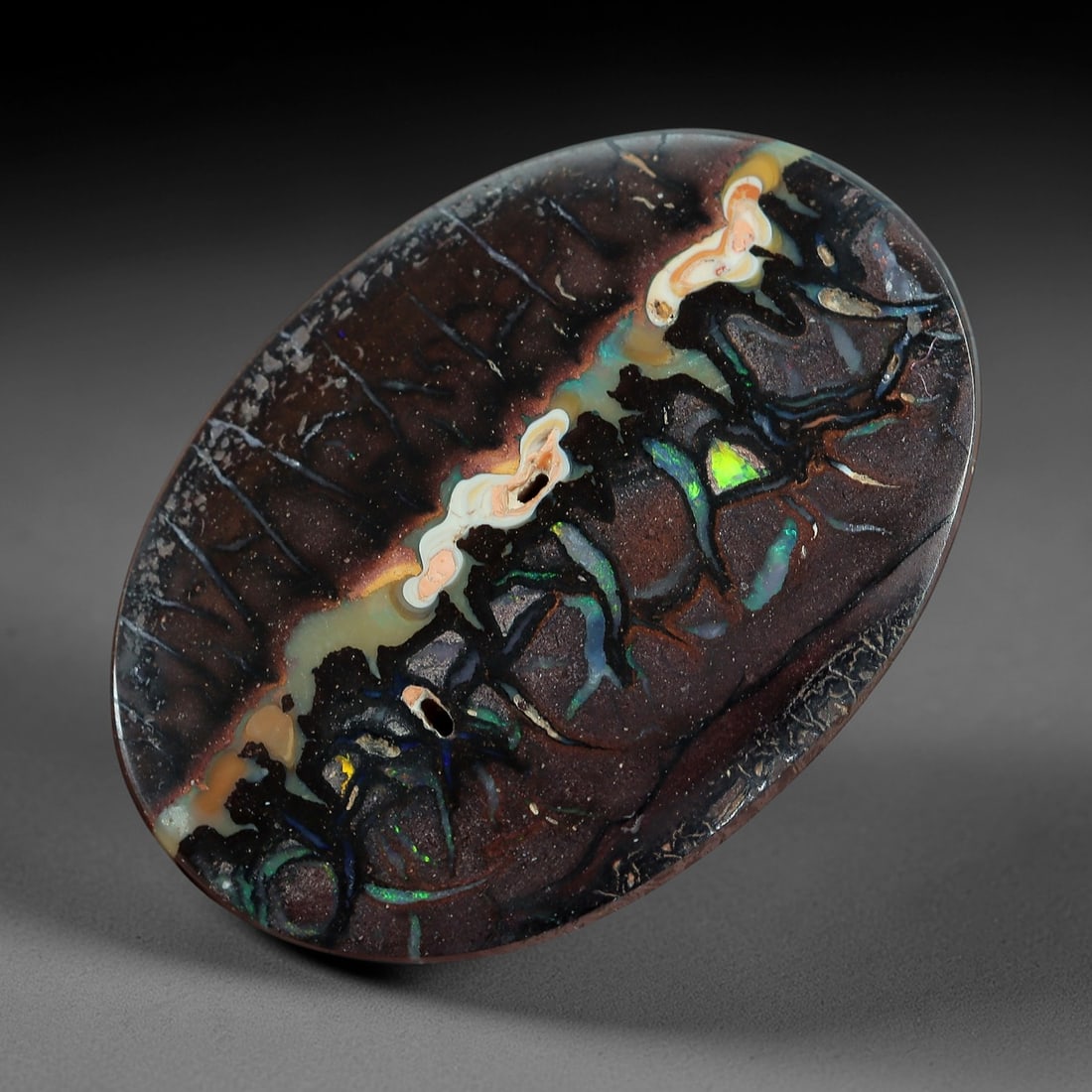 5.45 Carats Koroit Boulder Opal Cabochon - Natural Australian Stones 15.7x11.2mm, 3XM: This exceptional 5.45-carat Koroit boulder opal cabochon is a natural geological masterpiece, featuring a dramatic banded ironstone matrix interwoven with vivid veins of iridescent play-of-color. The