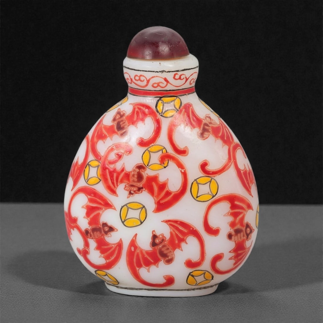 A Chinese Painted Glass Snuff Bottle, 20th Century, Guyuexuan Mark, 30FG: The bottle is formed from opaque white glass and decorated with polychrome enamels. The body is of rounded, flattened form, rising to a short cylindrical neck fitted with a metal-mounted mouth and a d