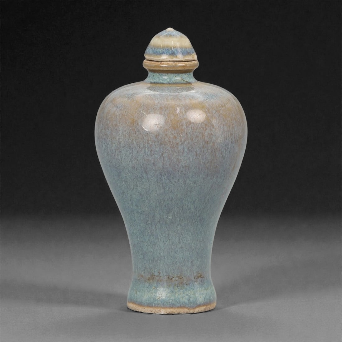 A Chinese Glazed Ceramic Snuff Bottle, 20th Century, 68FG: Thrown from ceramic body and covered with a mottled blue and buff glaze, the snuff bottle is formed with a pear-shaped body rising from a narrow foot to gently rounded shoulders and a short cylindrica