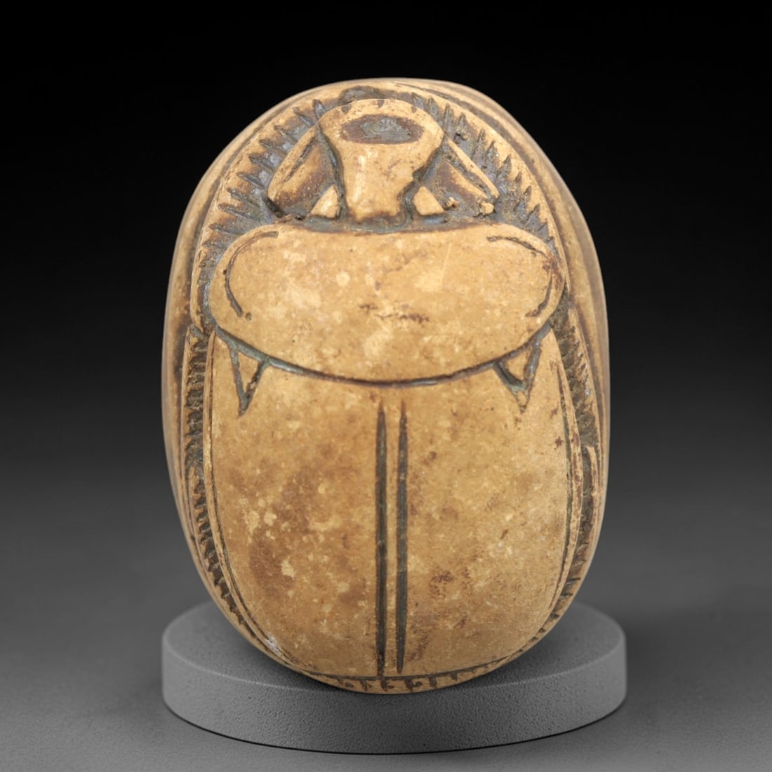 Ancient Steatite Scarab - Egyptian Amulet Seal, 99ZP: Carved from light tan steatite, this scarab amulet exhibits classic Egyptian craftsmanship with incised details defining the beetle's dorsal anatomy, including elytra, head, and leg structures. The re