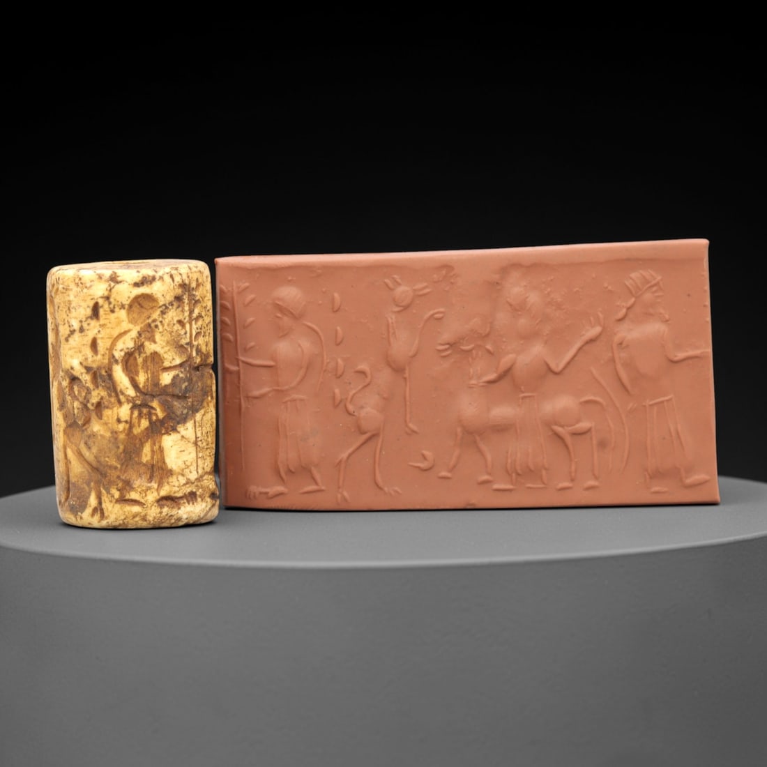 Ancient Steatite Cylinder Seal - Mesopotamian Figural & Animal Scene, 96ZR: Carved from dense steatite, this ancient Mesopotamian cylinder seal features a detailed linear relief composition of human figures interacting with equine and avian motifs, executed in the characteris