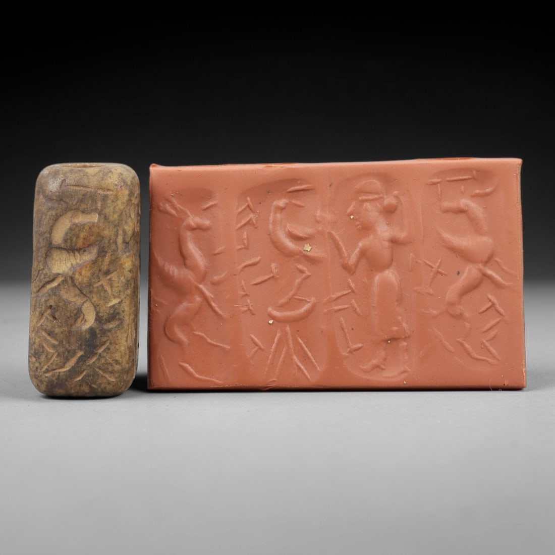 Ancient Steatite Cylinder Seal - Mesopotamian Figural & Animal Scene, 68AN: Carved from dense steatite, this ancient Mesopotamian cylinder seal features a detailed linear relief composition of a human figure interacting with caprine and avian motifs, executed in the character