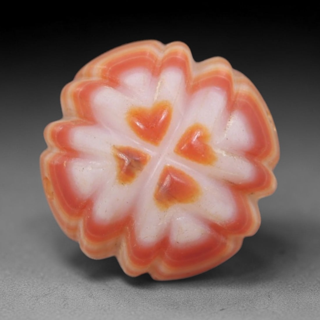 Antique Agate Flower Bead - Central Asian Carved Gemstone, 13AR: Carved from banded agate with creamy white and warm orange-red natural banding, this bead features a symmetrical floral form with scalloped petal edges and four heart-shaped central motifs. A lateral