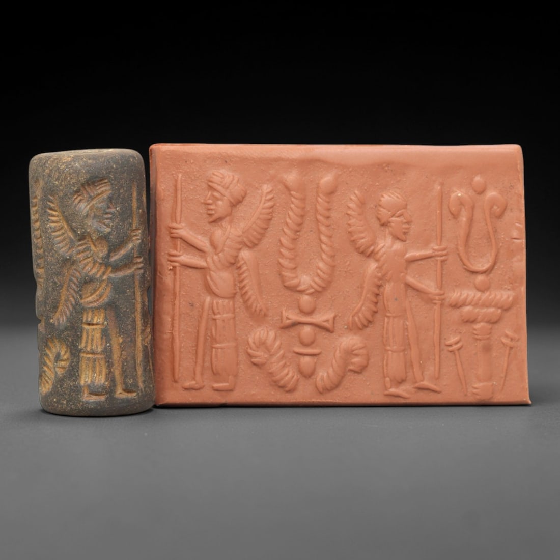 Ancient Steatite Cylinder Seal - Mesopotamian Anointing Scene, 31AL: Carved from dark, patinated steatite, this ancient Mesopotamian cylinder seal depicts a ritual anointing scene, executed with precise glyptic craftsmanship characteristic of Assyrian or Neo-Assyrian a
