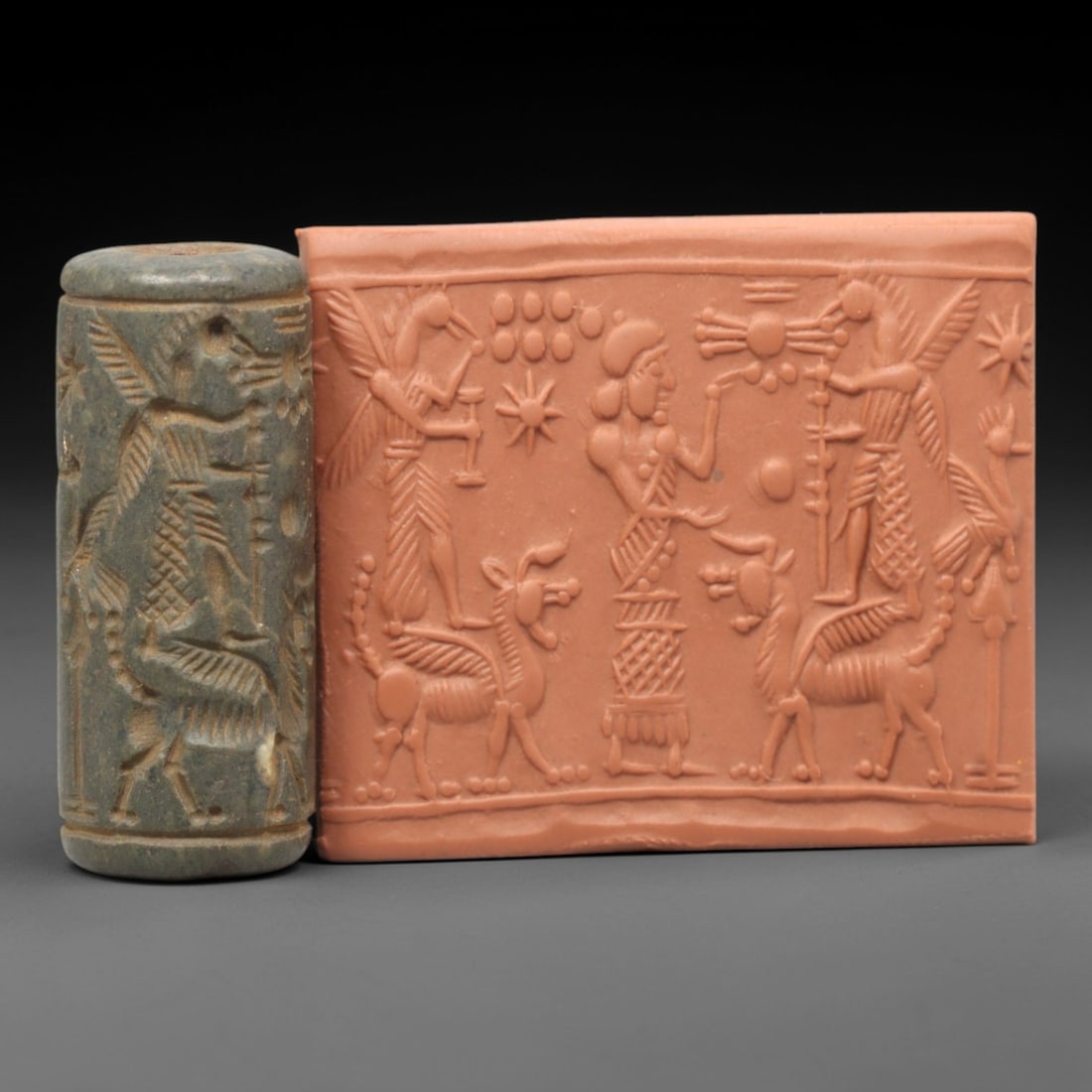Ancient Steatite Cylinder Seal - Mesopotamian Winged Genii & Mythical Beast Ritual Scene, 17ZP: Carved from dark, finely grained steatite, this ancient Mesopotamian cylinder seal depicts a rich ritual scene, executed with meticulous glyptic craftsmanship characteristic of the Late Bronze Age. Th