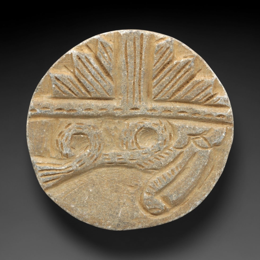 Ancient Stone Plaque - Indo Parthian Relief Figurine, 34ZR: This circular plaque is carved from a pale, granular stone with a matte, earthy patina consistent with ancient Indo-Parthian burial contexts. The raised relief is divided into two registers: the upper