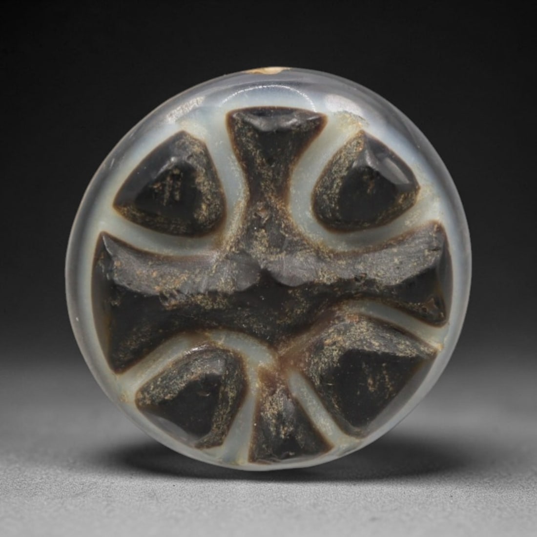 Antique Agate Cross Bead - Central Asian Gemstone Pendant, 12ZW: Carved from banded agate with a translucent milky-white base and deep black-brown inclusions, this bead features a symmetrical six-pointed cross motif with raised, faceted segments. A top perforation