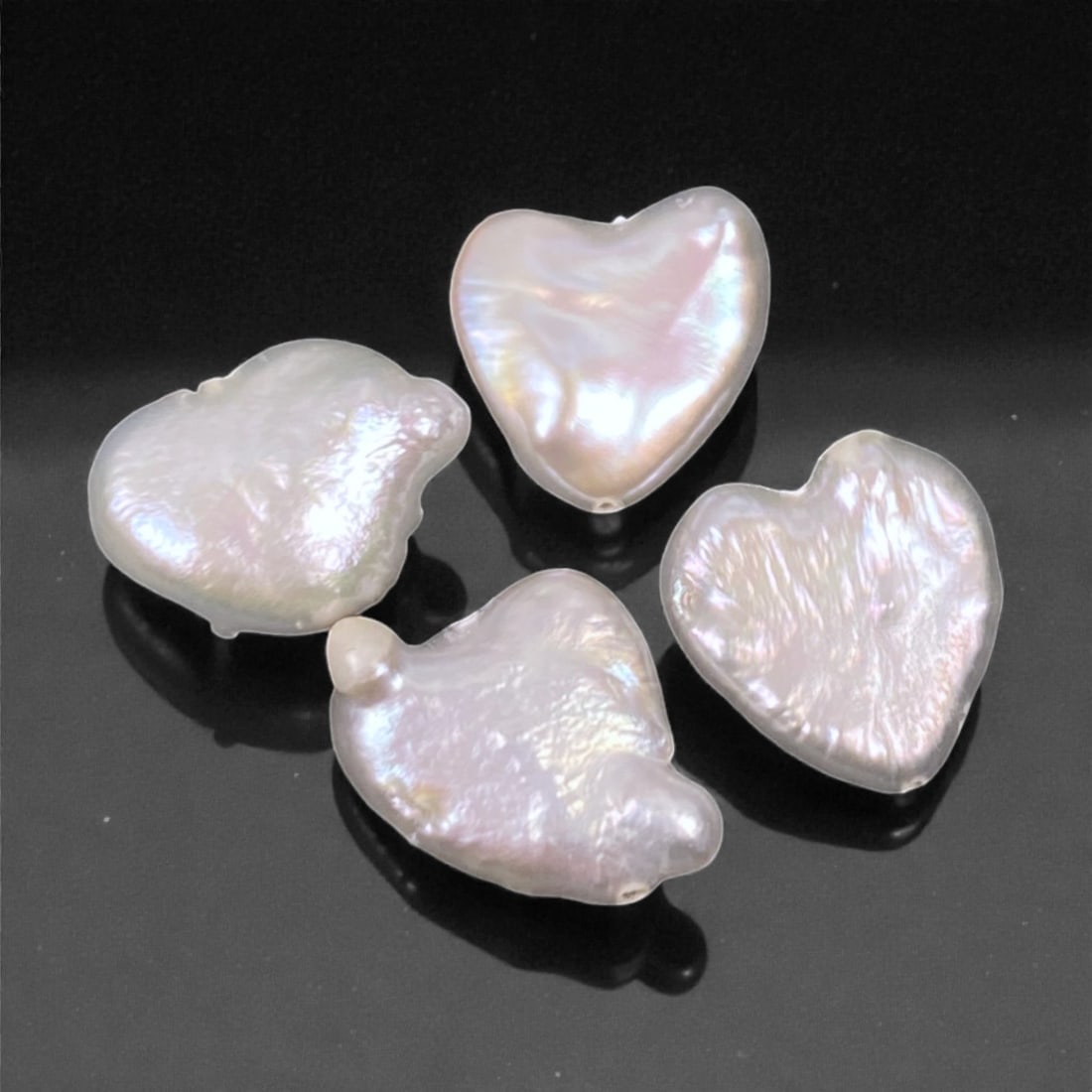 15.10 Carats Heart-Shaped Keshi Pearl Lot - Natural Freshwater Formation, 43XC: This enchanting lot of heart-shaped keshi pearls radiates soft romance and natural charm, with each piece measuring between 11 and 14mm. Their pastel body tones-ranging from soft ivory and rose to sub