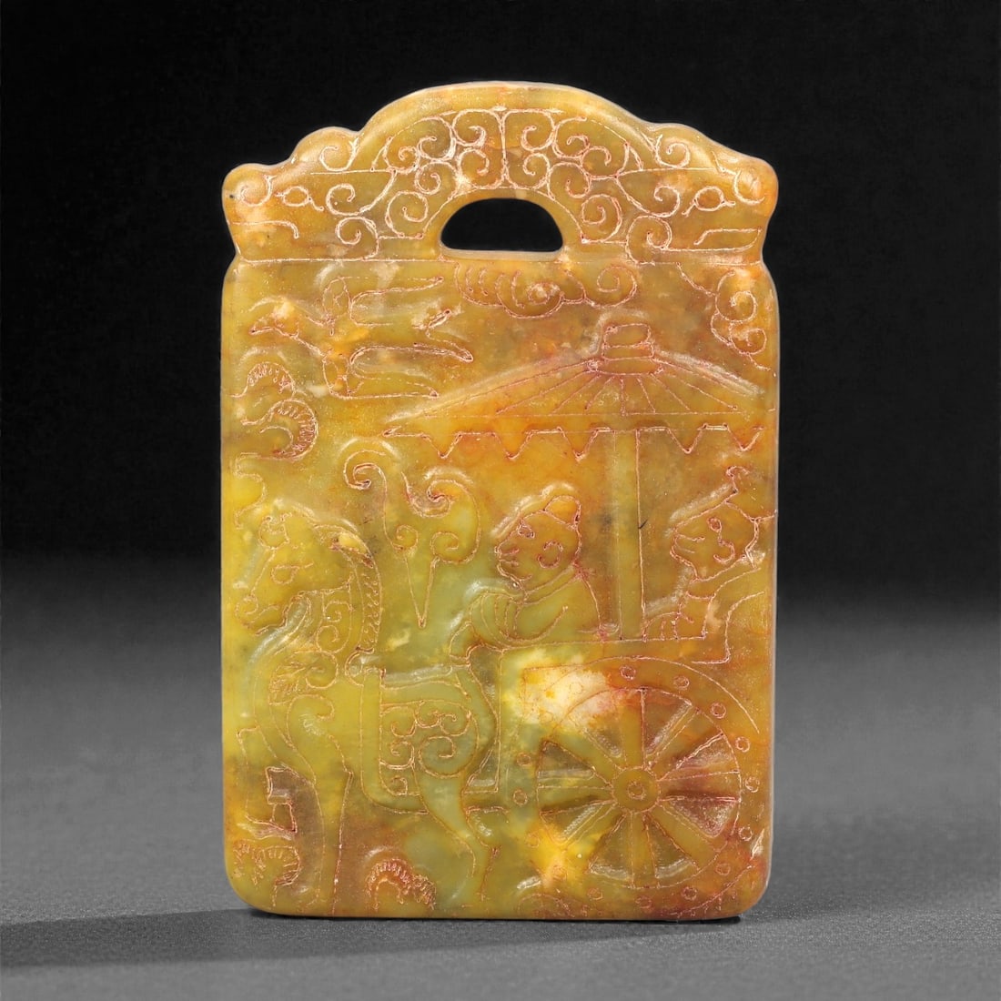 A Chinese Archaistic-Style Jade Figural Plaque, 20th Century, 45FH: Carved from yellow-green jade with mottled tonal variation, areas of russet staining, and natural inclusions, the plaque is rectangular in form with a scalloped upper edge and a pierced aperture for s