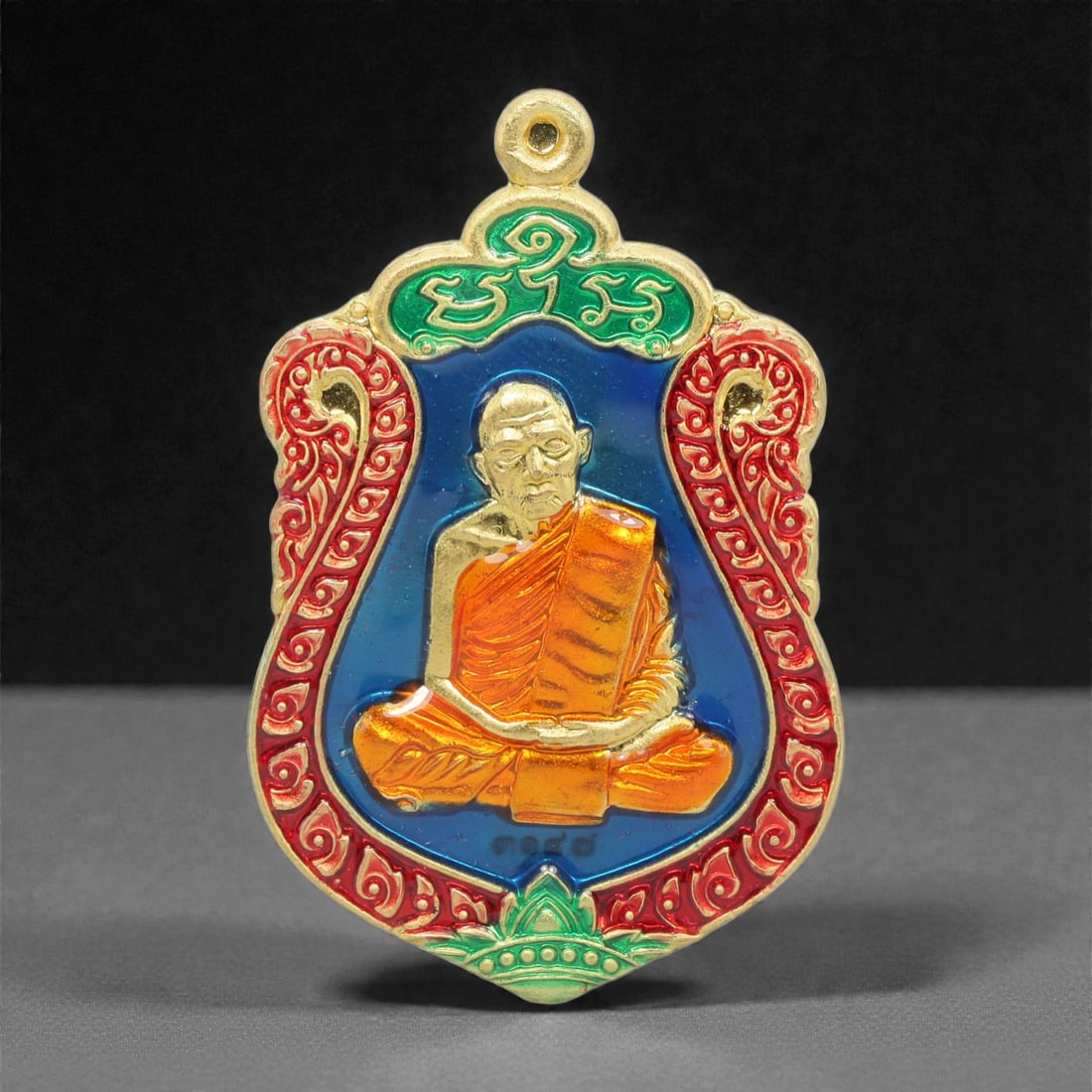 A Thai Gilt-Metal and Enamel Monk Portrait Amulet, 21st Century, 71FP (1 of 2)