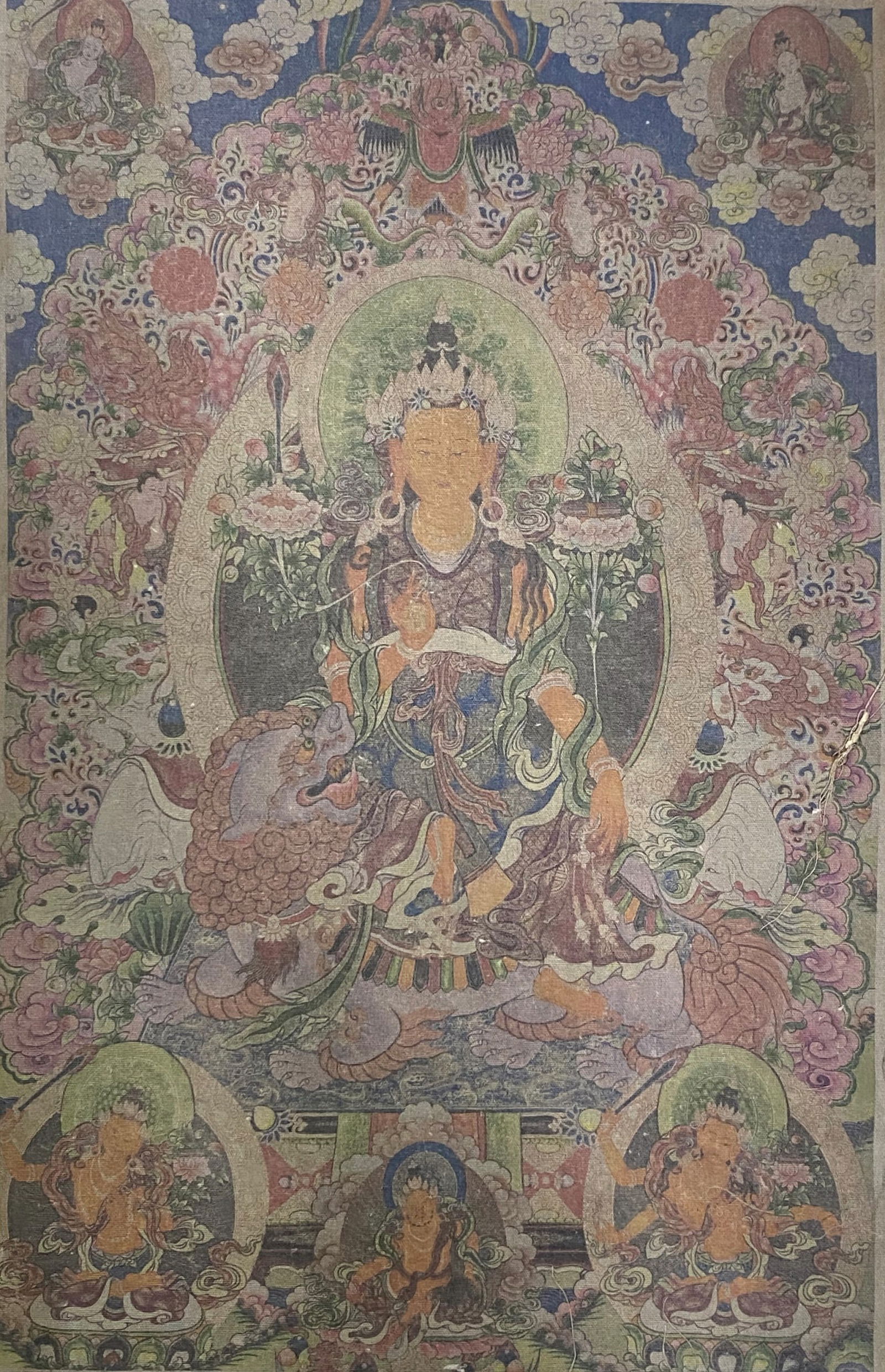 A Himalayan Ink and Color Art Print, Manjushri Thangka, 20th Century, 23FV: Printed on an aged textile or linen ground with visible patina and minor surface abrasion consistent with age, the composition depicts the Buddhist deity Manjushri at the center, seated dynamically at