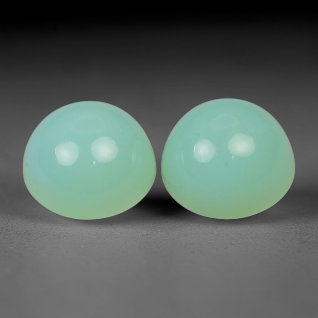 8.05 Carats Seafoam Green Chrysoprase Matched Pair - Natural Australian Stones, 91XN: This exceptional matched pair of chrysoprase cabochons, weighing a total of 8.05 carats with individual dimensions ranging from 9.4 to 9.8 mm, captivates with a uniform, dreamy seafoam green hue. The