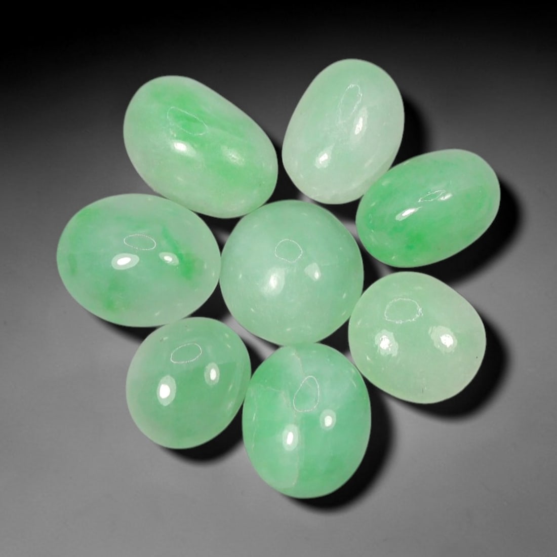 Natural Type A Jadeite Jade - Loose Cabochon Gemstone, 2AP: Crafted from natural Type A jadeite jade, these eight cabochons exhibit a translucent pale green hue with subtle tonal variations inherent to the material. Each stone is cut en cabochon with a smooth,