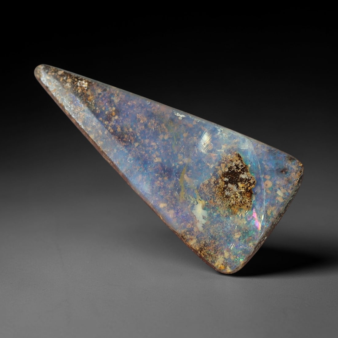 1.99 Carats Iridescent Blue and Violet Boulder Opal Cabochon - Natural Australian Stone, 59XM: This striking boulder opal cabochon features a translucent, milky base infused with delicate iridescent flashes of blue and violet, set against a contrasting matrix of earthy brown and golden inclusio