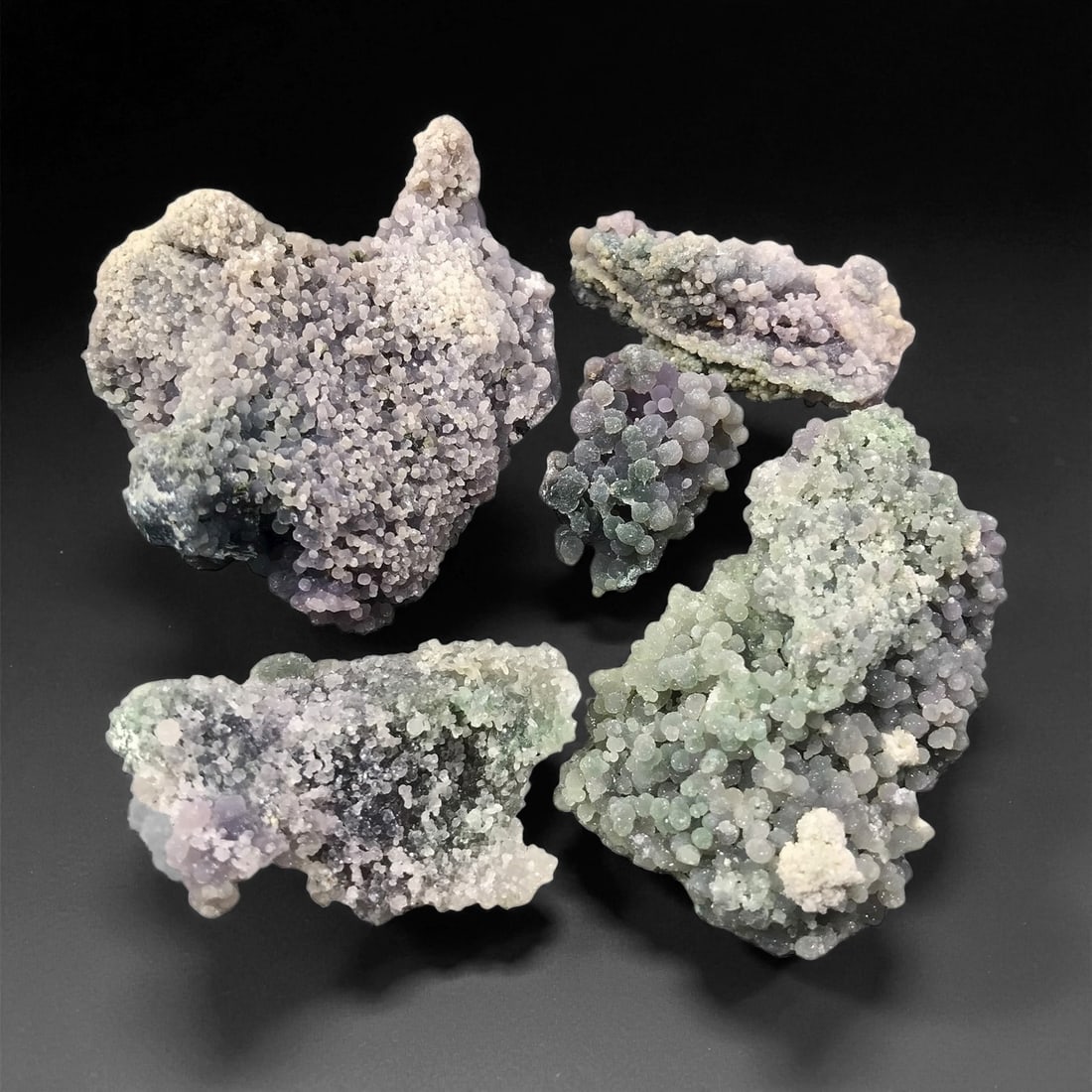 A Group of Five Grape Agate Specimens, 65EQ: Comprising five specimens of botryoidal chalcedony, widely known as "Grape Agate," each piece exhibits the iconic morphology of tightly clustered, sub-spherical micro-nodules forming distinct grape-li