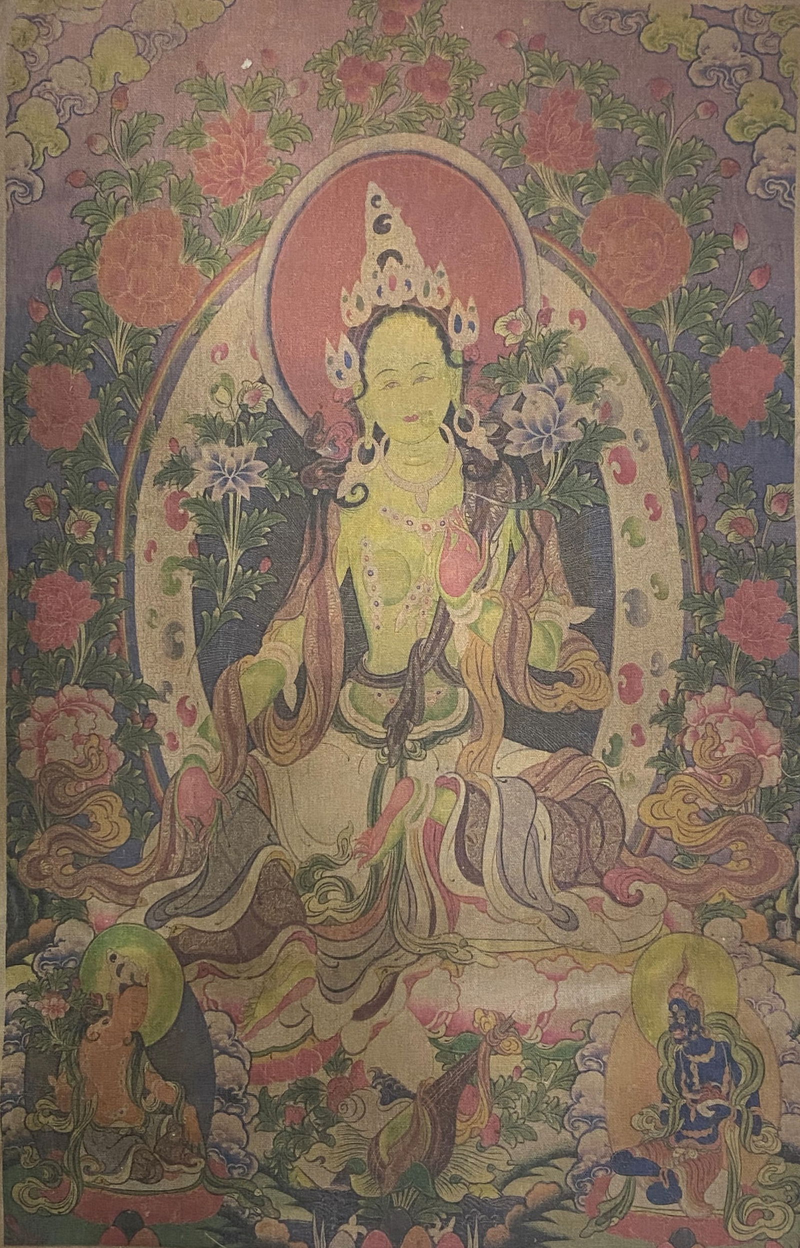 A Chinese Ink and Color Art Print, Green Tara Thangka, 20th Century, 22FV: Printed on an aged textile or linen ground, the composition depicts the Buddhist deity Green Tara in a seated, meditative pose at the center of the composition. The figure is rendered with a green com