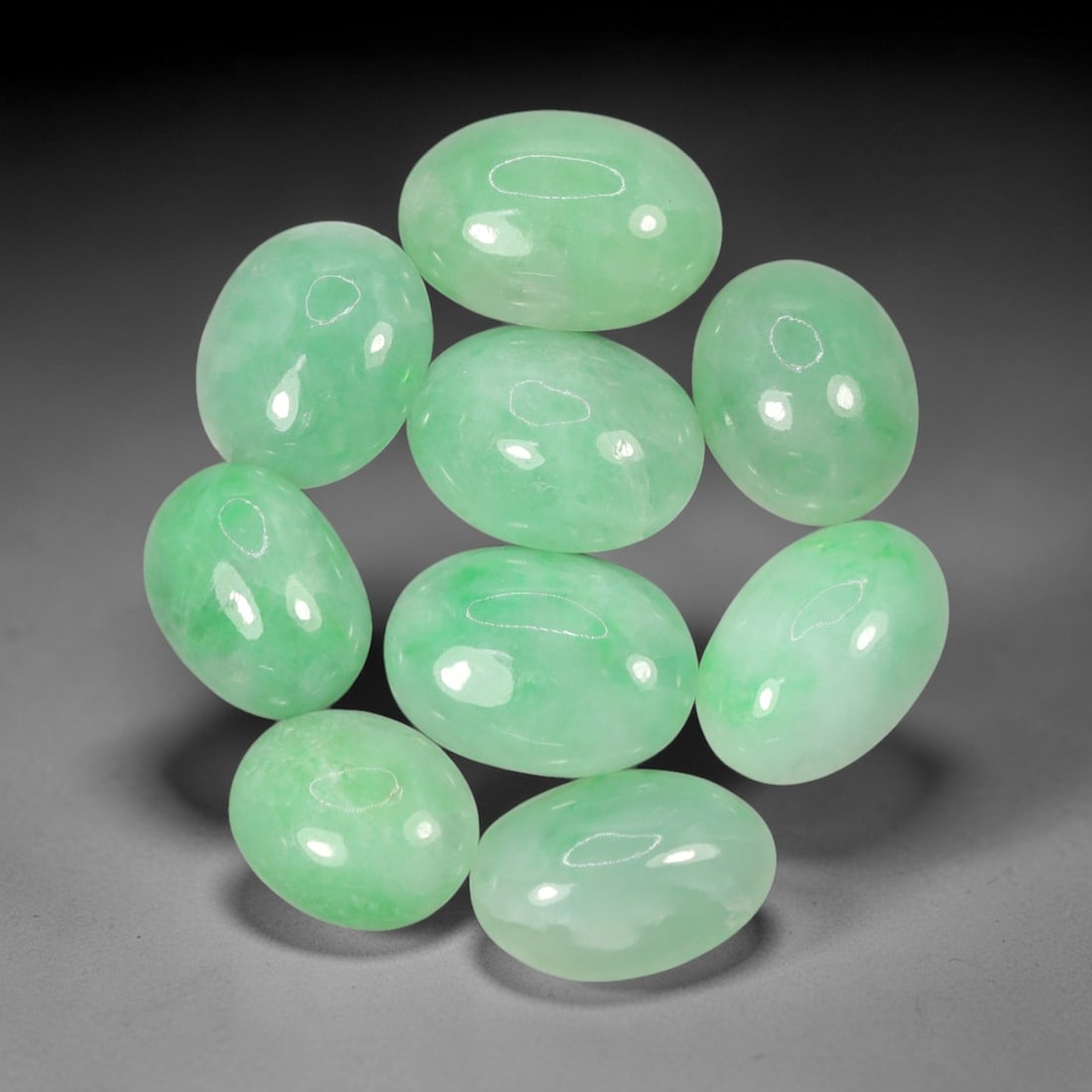 Natural Type A Jadeite Jade - Loose Cabochon Gemstone, 97AN: Crafted from natural Type A jadeite jade, these nine cabochons exhibit a translucent pale green hue with subtle tonal variations inherent to the material. Each stone is cut en cabochon with a smooth,