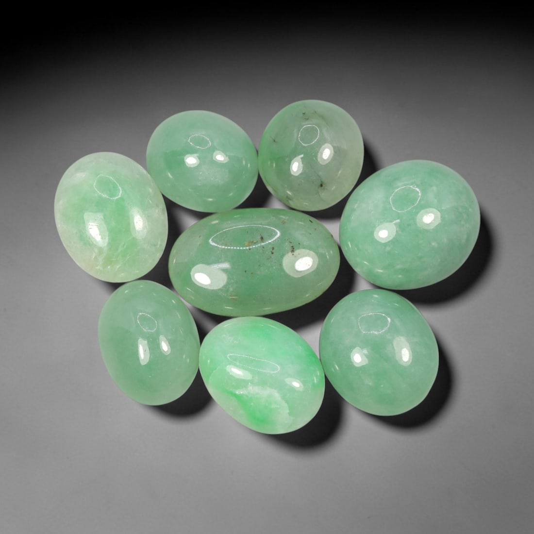 Natural Type A Jadeite Jade - Loose Cabochon Gemstone, 4AP: Crafted from natural Type A jadeite jade, these cabochons exhibit a smooth, domed form with a polished, glossy finish that highlights the material's translucent, pale green hue. Each stone is cut en c