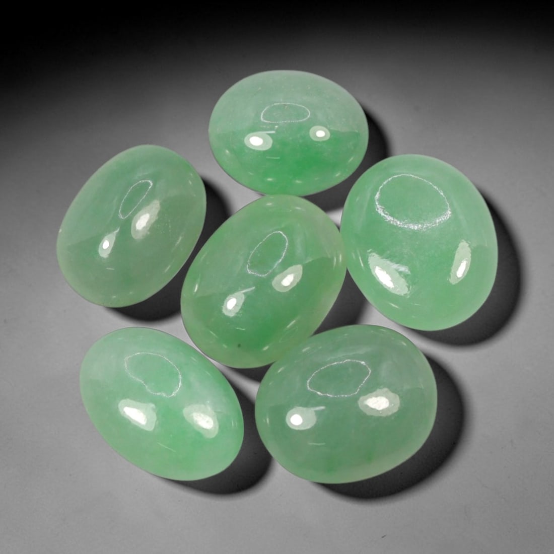 Natural Type A Jadeite Jade - Loose Cabochon Gemstone, 6AP: Comprising six polished cabochons, these pieces are crafted from natural Type A jadeite jade, featuring a delicate pale green hue with subtle translucency characteristic of authentic jadeite. Each sto