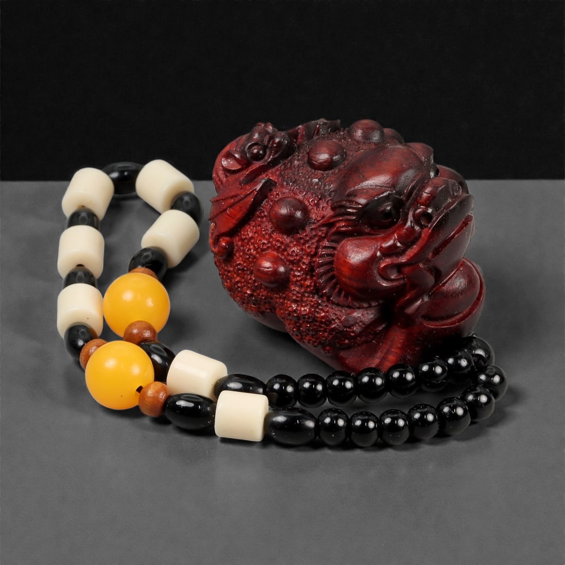 A Chinese Wood Bixi Figure, 20th Century, 60FD: Carved from dark reddish-brown wood with a polished surface, the figure represents a bixi, the mythical creature combining the body of a tortoise with a dragon-like head. The head is modeled with pron