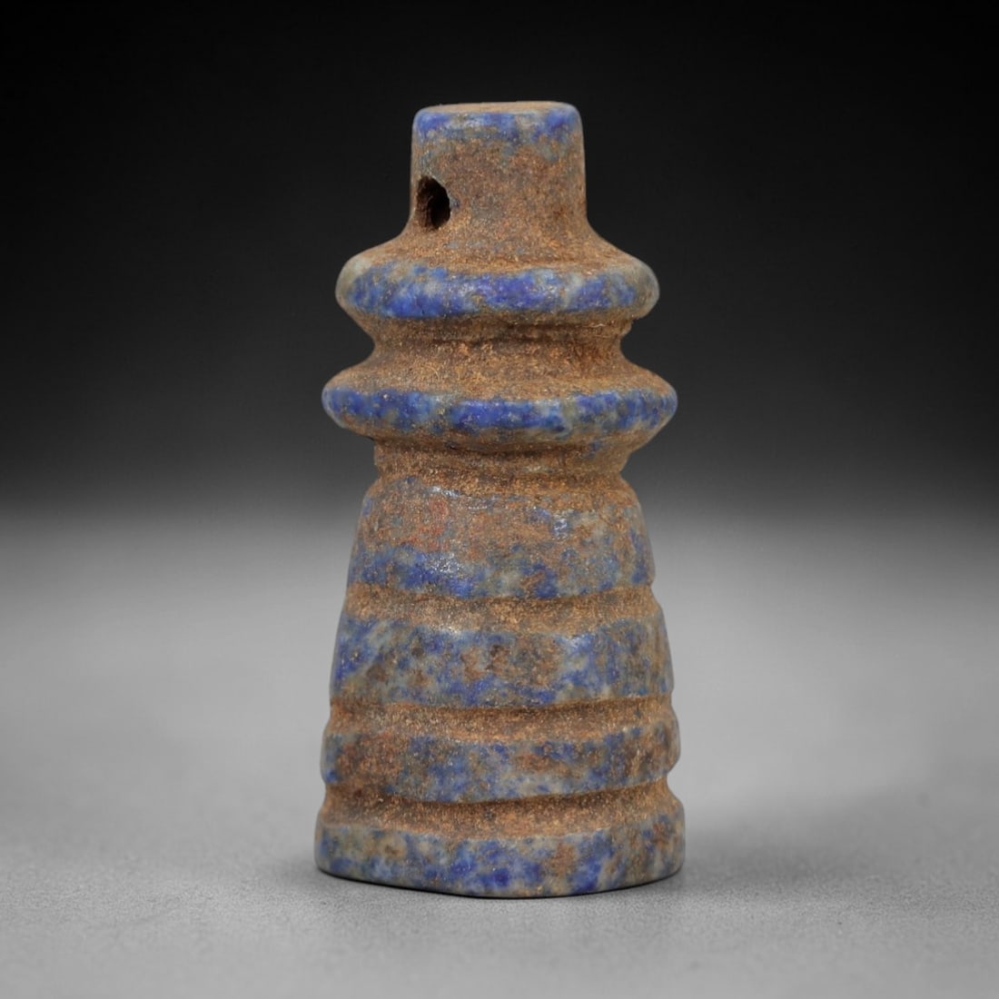 Ancient Lapis Lazuli Djed Amulet - Egyptian Ritual Pendant, 22AP: Carved from lapis lazuli, this amulet is formed in the shape of the djed pillar, a symbol of stability and Osiris in ancient Egyptian religion, with horizontal incised bands defining its segmented for
