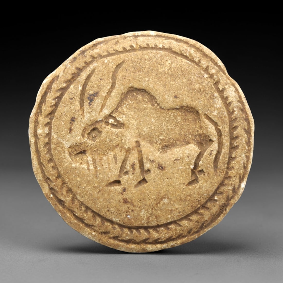 Ancient Stone Double Convex Amulet Bead - Near Eastern Animal Figurine, 93ZP: This artifact is a carved stone double convex amulet bead, featuring distinct zoomorphic motifs on each convex face, executed in the stylized glyptic tradition of the ancient Near East. One face depic