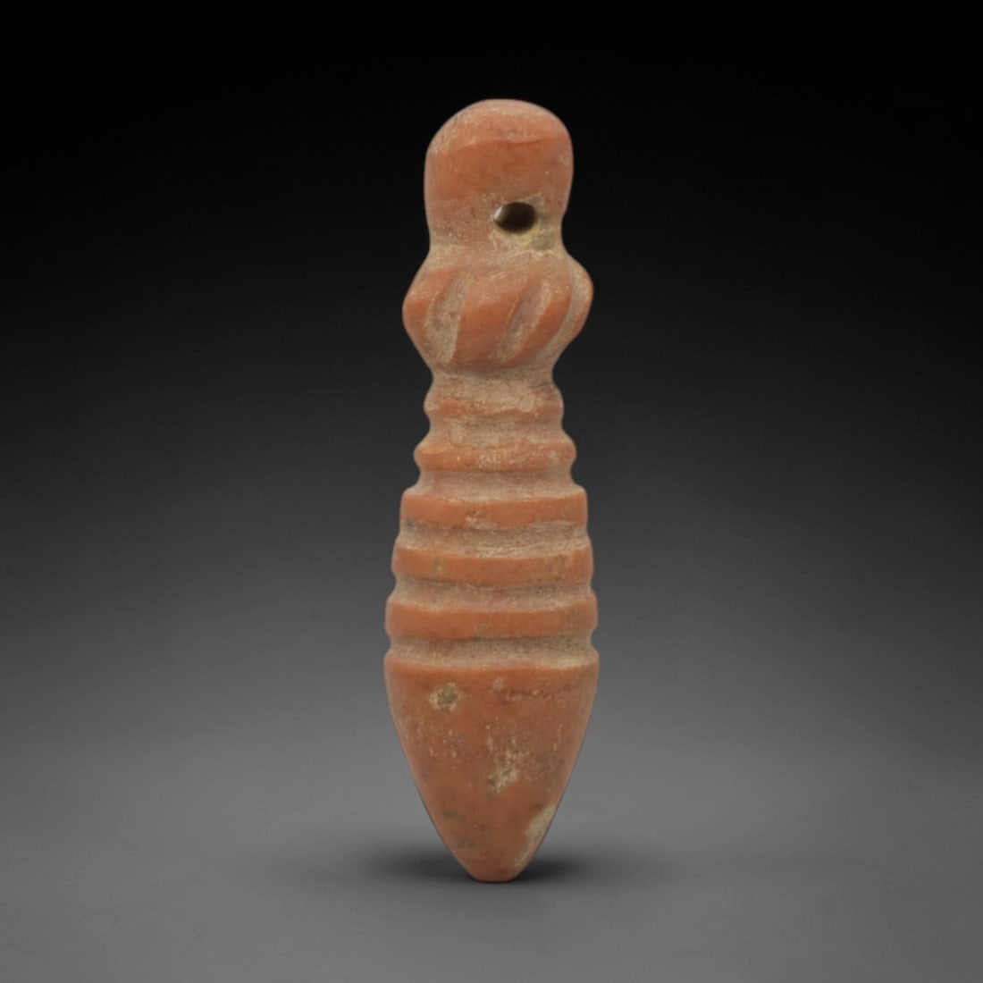 Ancient Egyptian Papyrus Sceptre Amulet - Egyptian Stone Pendant, 63XQ: This amulet is carved from a warm, reddish-orange stone, shaped into a stylized papyrus sceptre form with a perforated suspension hole at the rounded upper tip, confirming its use as a wearable protec