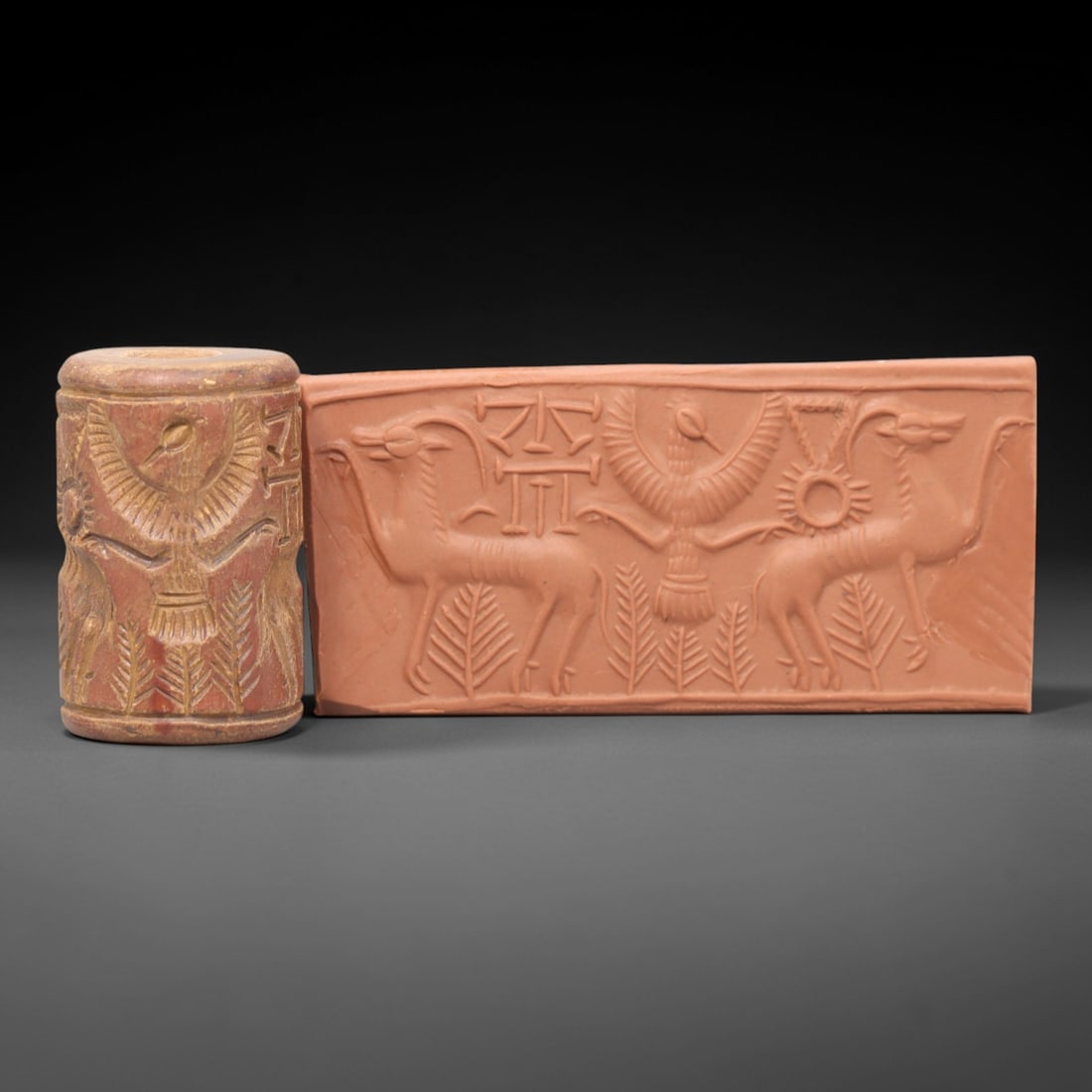 Ancient Steatite Cylinder Seal - Mesopotamian Bird And Ibex Scene, 41AL: Carved from warm, earthy steatite, this ancient Mesopotamian cylinder seal depicts a symmetrical scene of confronting ibexes, executed with precise glyptic craftsmanship characteristic of Mesopotamian