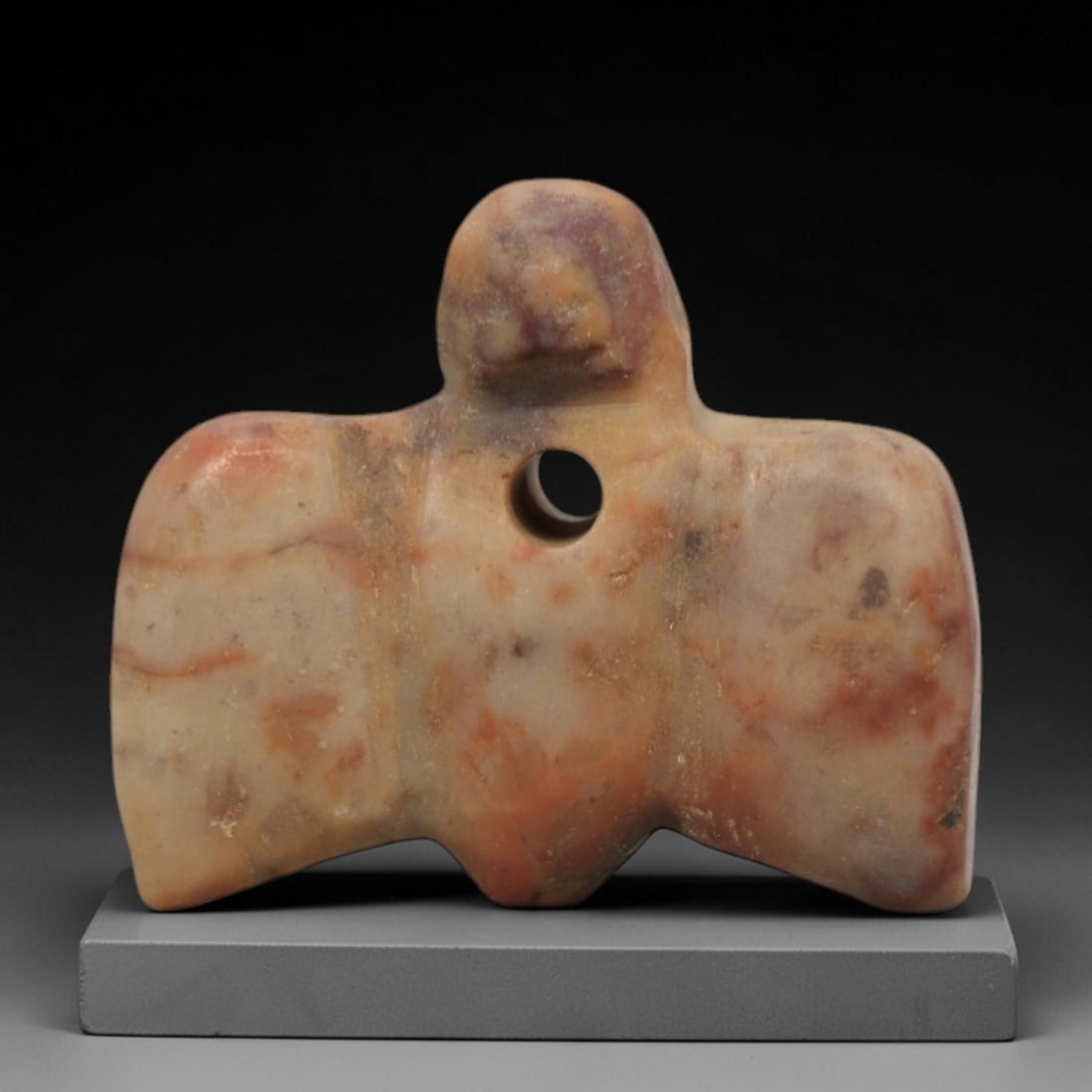 Ancient Egyptian Variegated Stone Vulture Amulet - Carved Pendant Figure, 16ZV: This amulet is carved from a pale, creamy stone with natural reddish and purplish veining, likely calcite or travertine, with a stylized vulture form. The piece features a rounded head with simplified