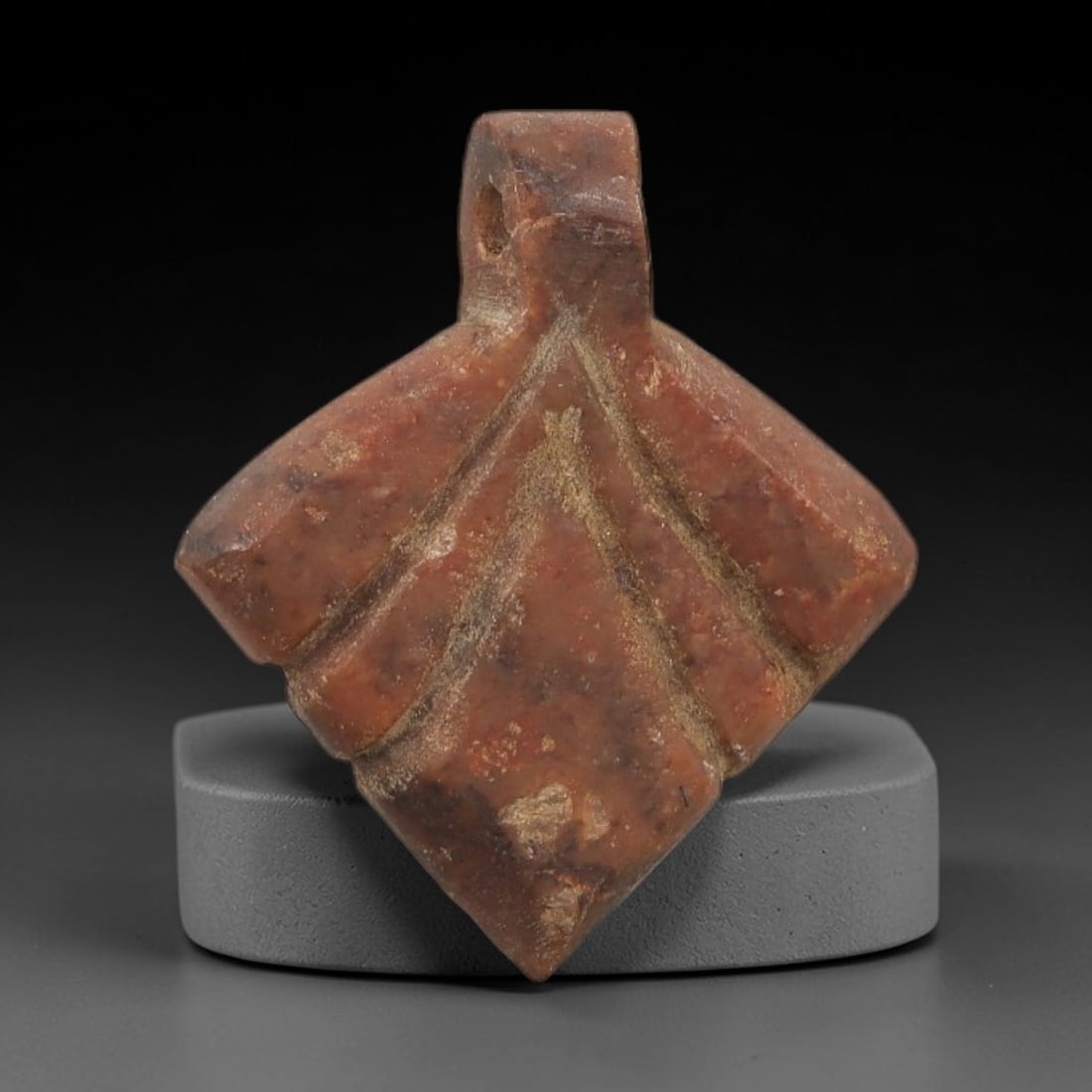 Ancient Egyptian Stone Amulet - Triangular Carving, 52AG: Carved from stone, this ancient Egyptian amulet features a triangular form with incised linear detailing, typical of protective amulets from the Late Period (c. 664-332 BCE). The triangular shape was