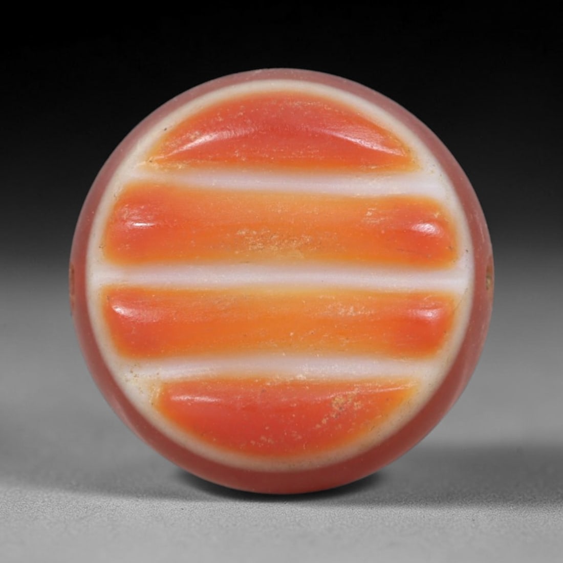 Antique Agate Stripe Bead - Central Asian Gemstone Pendant, 14AR: Carved from banded agate with a soft pinkish base and bold horizontal orange-white stripe patterns, this bead features a smooth, flattened spherical form with lateral perforations for wearability. The