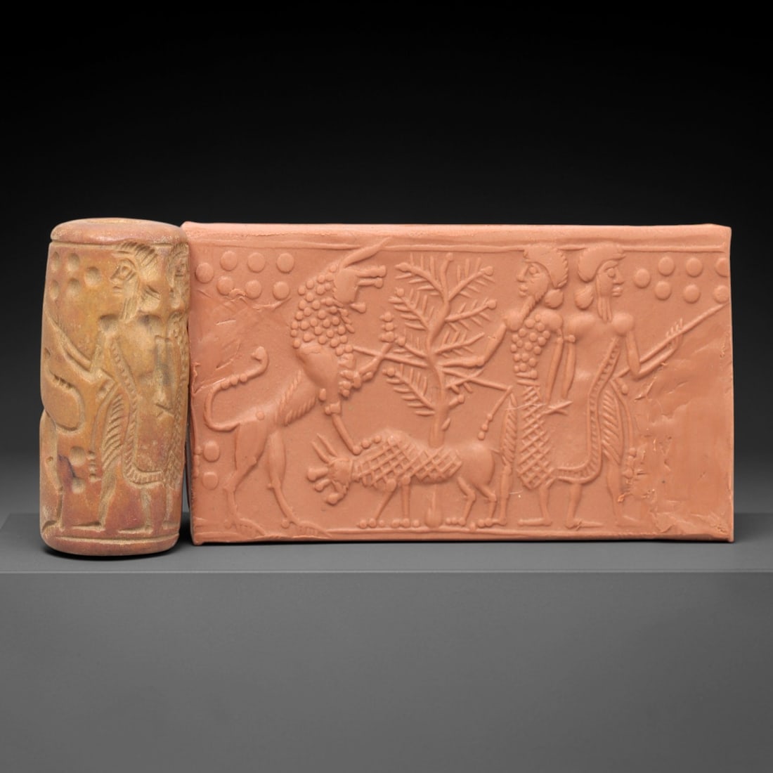 Ancient Steatite Cylinder Seal - Mesopotamian Sacred Tree Scene, 47AL: Carved from steatite with a rich, variegated patina, this ancient Mesopotamian cylinder seal features a finely rendered sacred tree and figural scene, executed with precise glyptic craftsmanship typic