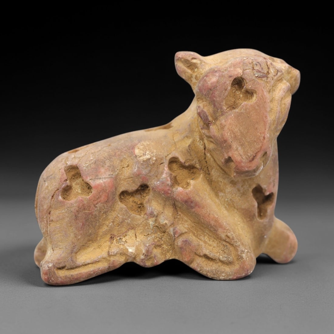 Ancient Mesopotamian Bovid Effigy - Stone Protective Figurine, 8ZR: This artifact is a stone bovid effigy, executed in the stylized zoomorphic tradition of ancient Mesopotamia. The figurine depicts a reclining bovine (likely a sheep or ram) with simplified anatomical