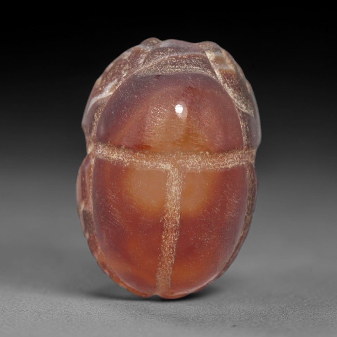 Ancient Agate Scarab - Egyptian Amulet Bead, 92XS: This amulet is carved from rich reddish-brown agate, exhibiting natural banding and a glossy, polished finish characteristic of ancient Egyptian glyptic craftsmanship. The form is a classic scarab bee