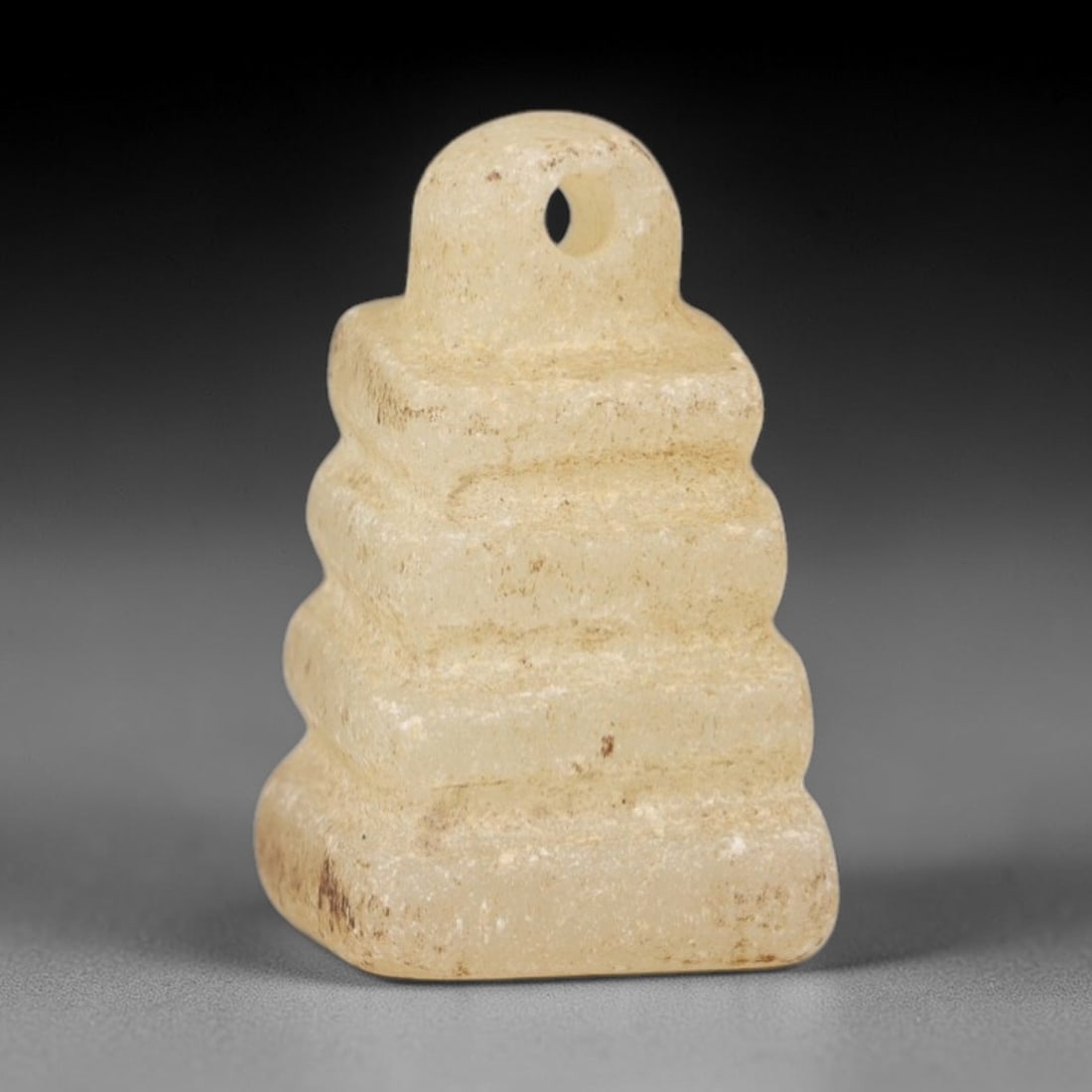 Ancient Rock Crystal Pyramid - Egyptian Amulet Pendant, 79AR: This artifact is carved from translucent, pale rock crystal, exhibiting a smooth, matte finish with subtle natural inclusions and faint surface wear consistent with age. The form is a stepped pyramid
