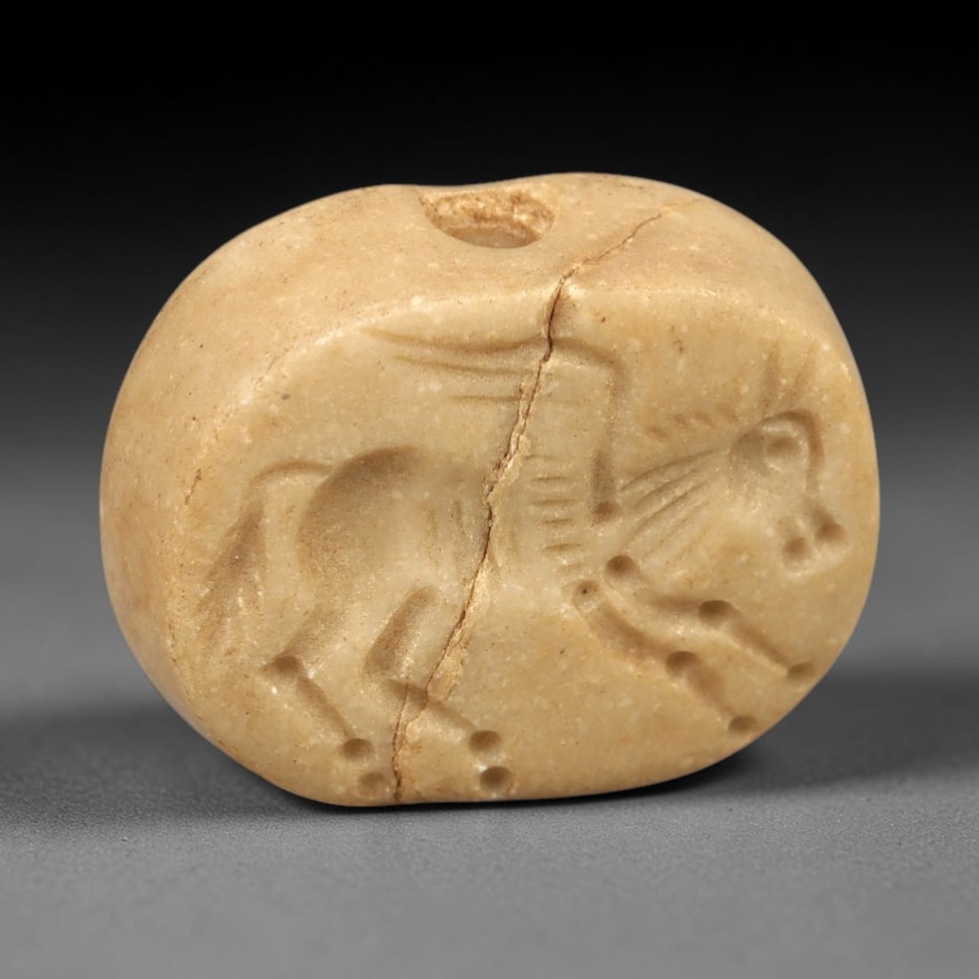 Ancient Steatite Stamp Seal - Near Eastern Horse Figure, 85AM: Carved from pale beige steatite, this hemispherical stamp seal depicts a striding equine figure with incised linear details defining its mane, body, and stylized limbs. The iconography reflects the an