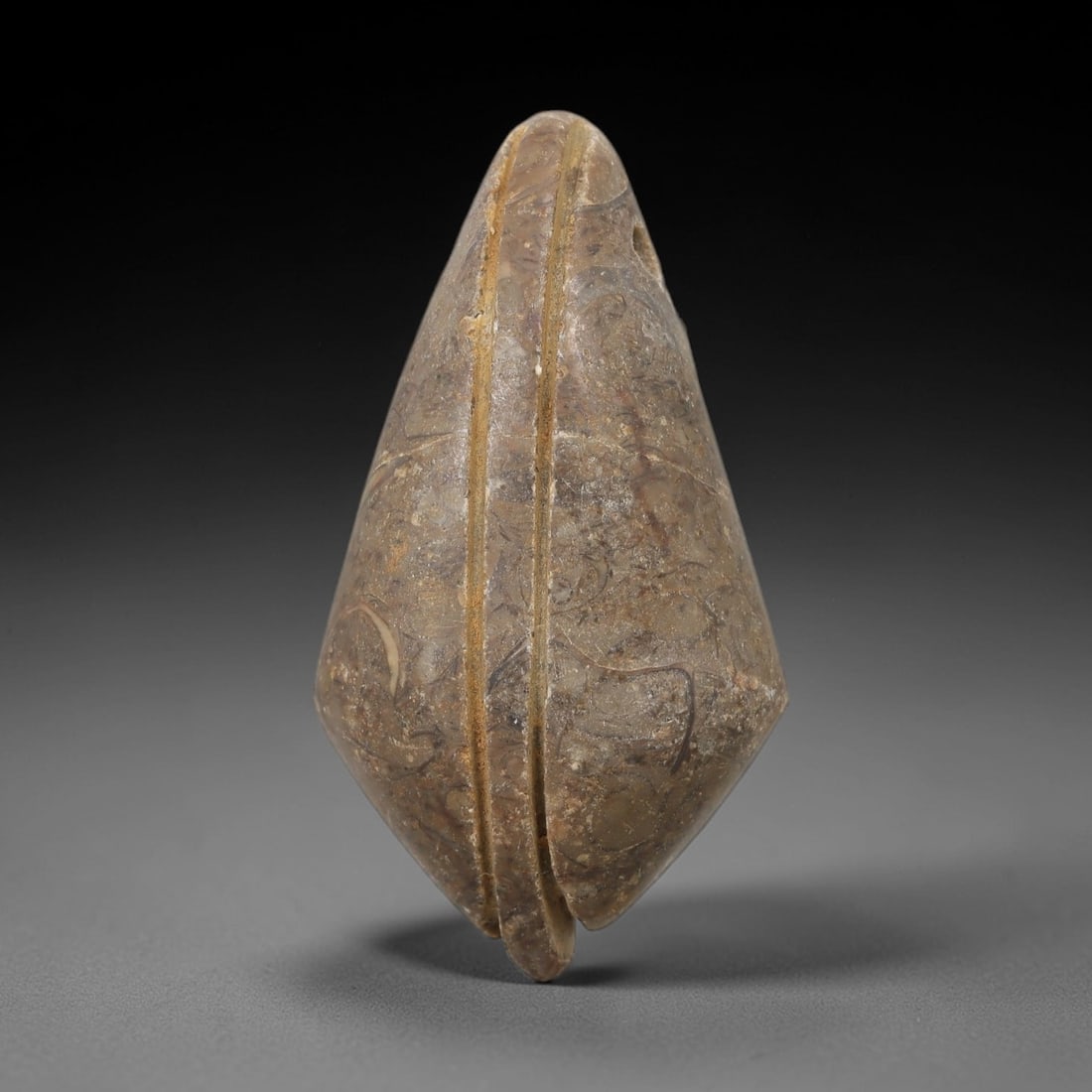 Ancient Egyptian Stone Amulet - Geometric Carved Pendant, 26AE: Carved from light-toned stone with subtle banding, this ancient Egyptian amulet features an oval, elongated form typical of protective amulets. The carving is simple yet deliberate, with smooth surfac