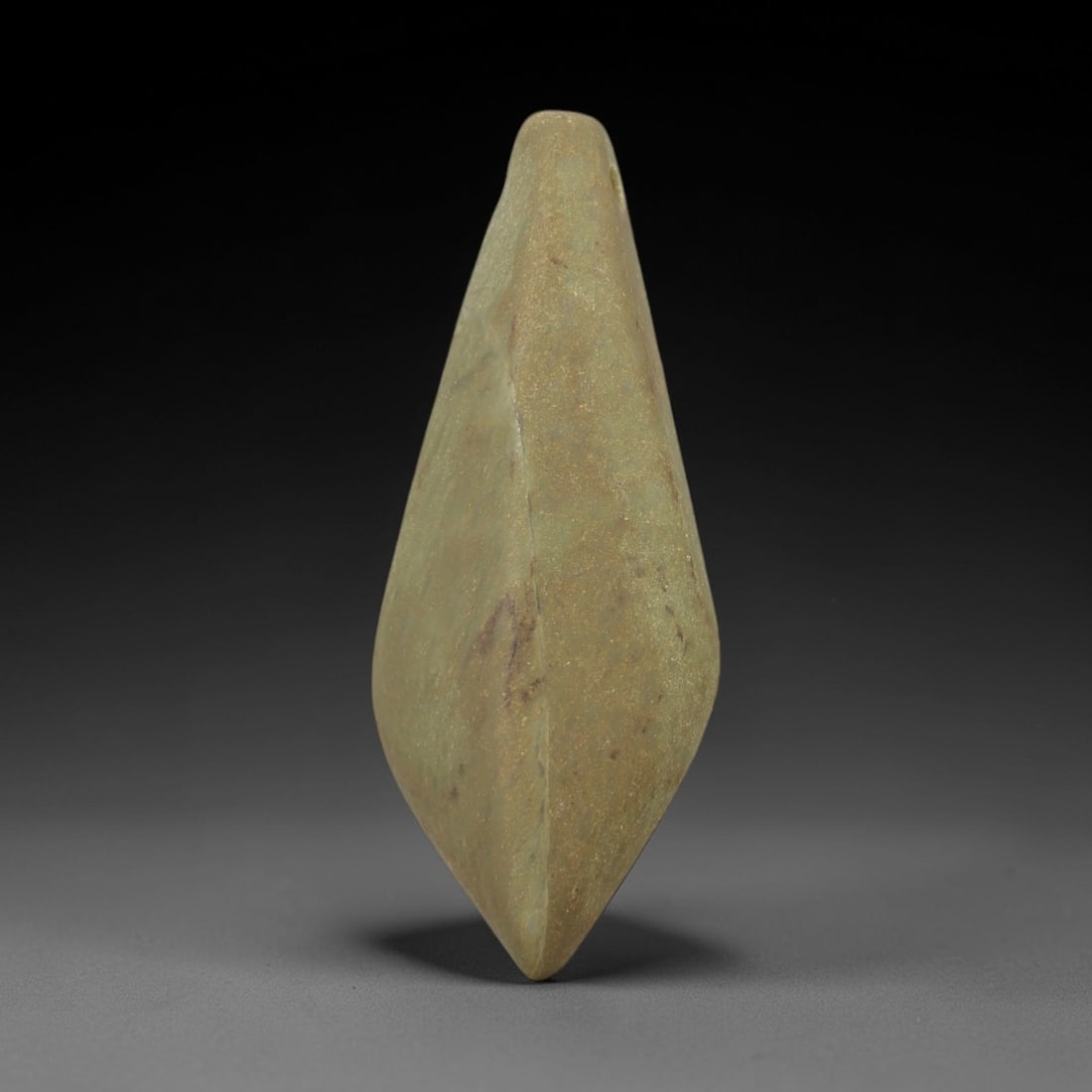 Ancient Green Stone Lozenge Amulet - Near Eastern Pendant, 27AE: This artifact is a carved green stone lozenge amulet of Near Eastern origin, fashioned from a mottled olive-green stone with subtle mineral veining and fine granular texture. Its symmetrical, elongate