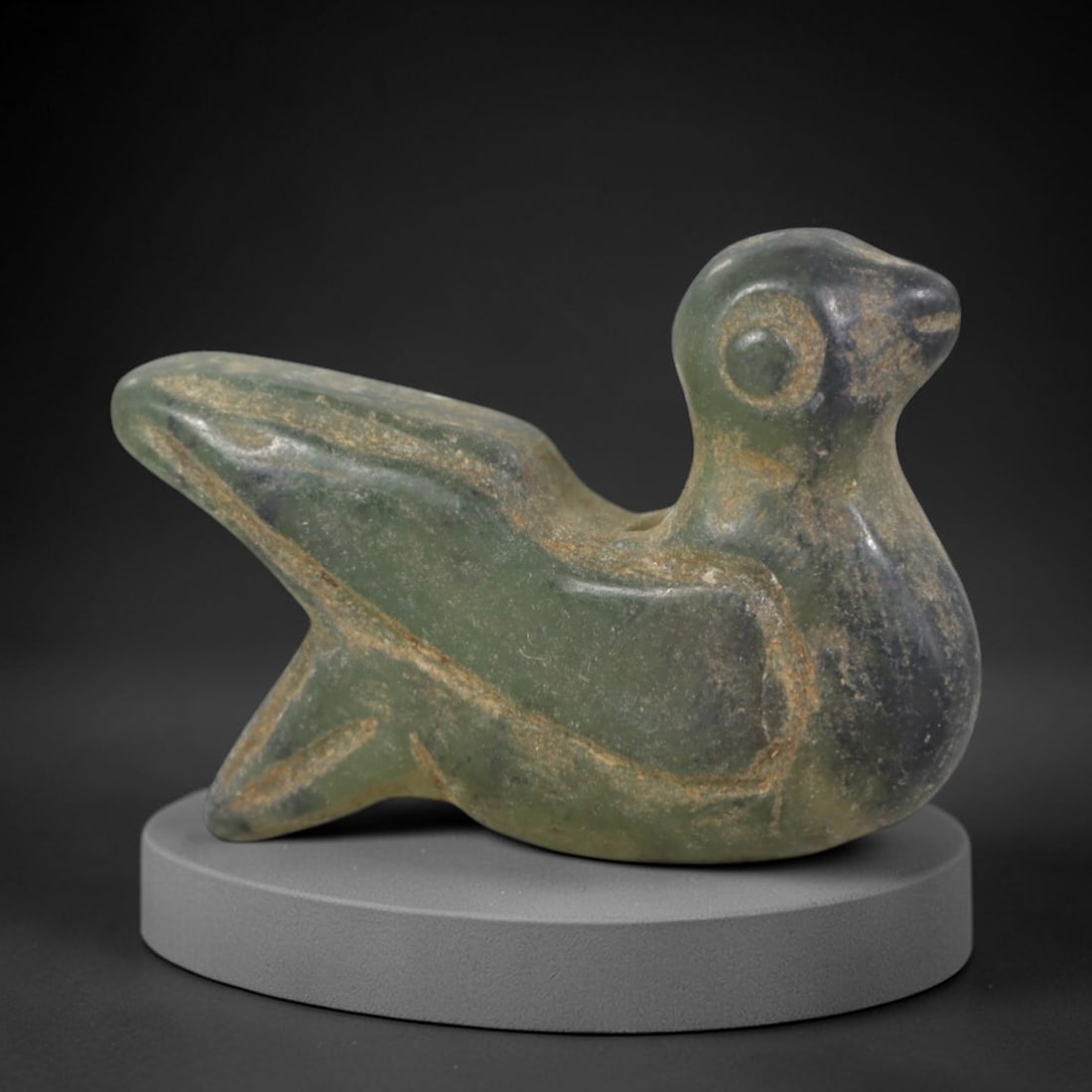 Ancient Serpentine Bird - Near Eastern Amulet Figurine, 50AP: This artifact is carved from serpentine with a weathered, earthy patina and subtle mineral veining, exhibiting stylized avian features consistent with ancient Near Eastern stoneworking techniques. The