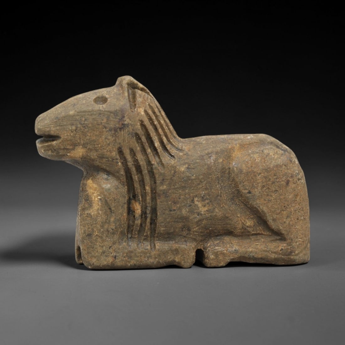 Ancient Stone Equine Effigy Amulet - Near Eastern Protective Figurine, 90ZP: This artifact is a carved stone equine effigy amulet, executed in the stylized zoomorphic tradition of the ancient Near East. The amulet depicts a recumbent horse or donkey with simplified anatomical