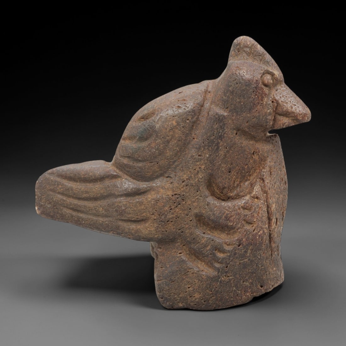Ancient Bone Bird - Mesopotamian Animal Figurine, 32FX: Carved from a porous, weathered bone, this Mesopotamian bird figure exhibits stylized avian forms with incised lines defining the wings, tail, and facial contours, including a pointed beak and recesse