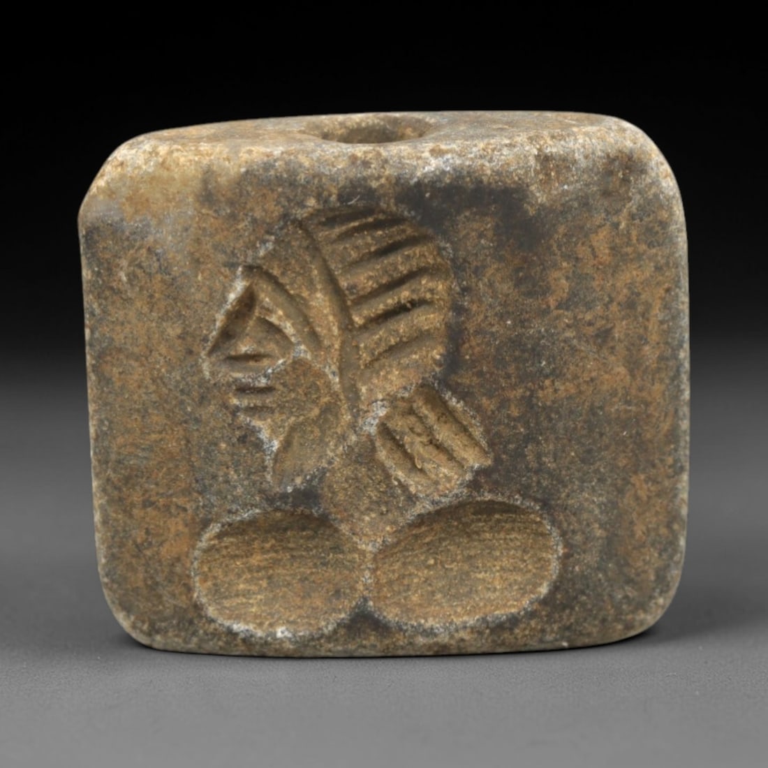 Ancient Schist Double Convex Intaglio Bead Amulet - Near Eastern Deity Motif, 10ZS: This ancient Near Eastern double convex intaglio bead amulet is carved from dense, weathered schist, with a muted, earthy patina indicative of long-term burial. The single bead features two distinct i
