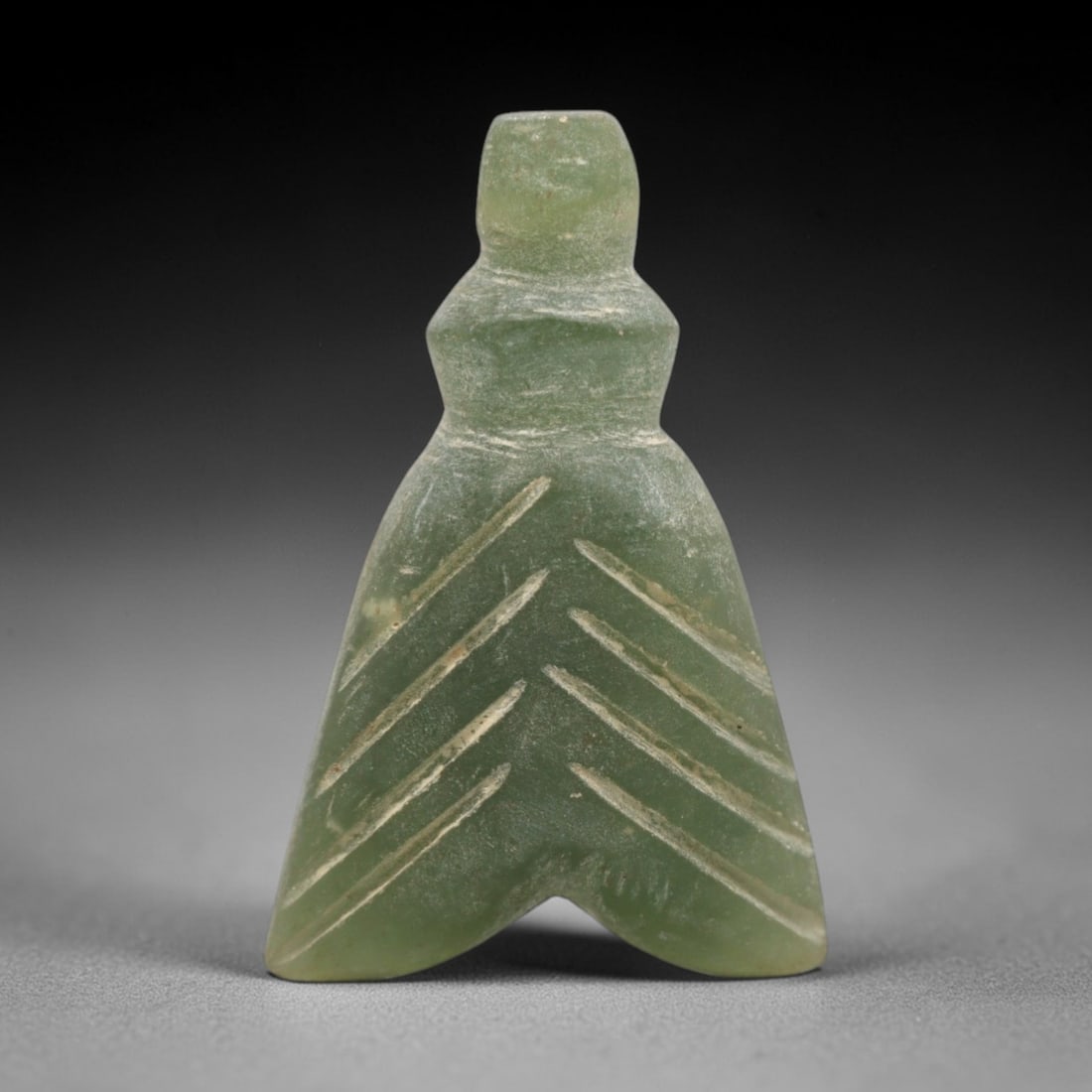 Ancient Serpentine Fly Amulet - Egyptian, 69ZW: Carved from serpentine, this amulet takes the stylized form of a fly, a motif with protective significance in ancient Egyptian culture. The piece features incised linear detailing to denote the fly's