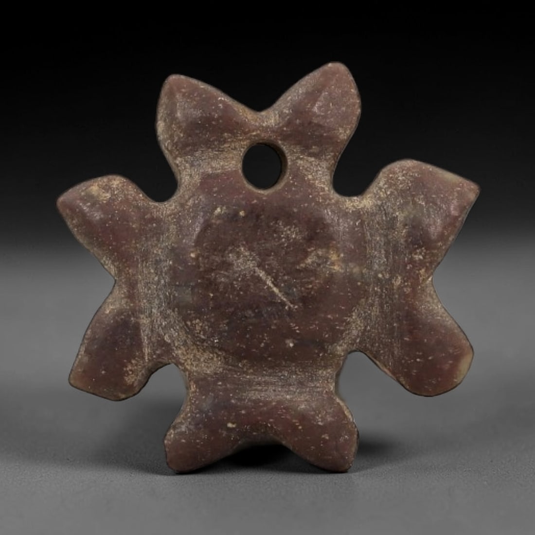 Ancient Egyptian Stone Amulet - Star-Shaped Carving, 68AG: Carved from stone, this ancient Egyptian amulet features a star-shaped form with incised detailing, typical of protective amulets from the Late Period (c. 664-332 BCE). The star motif was associated w