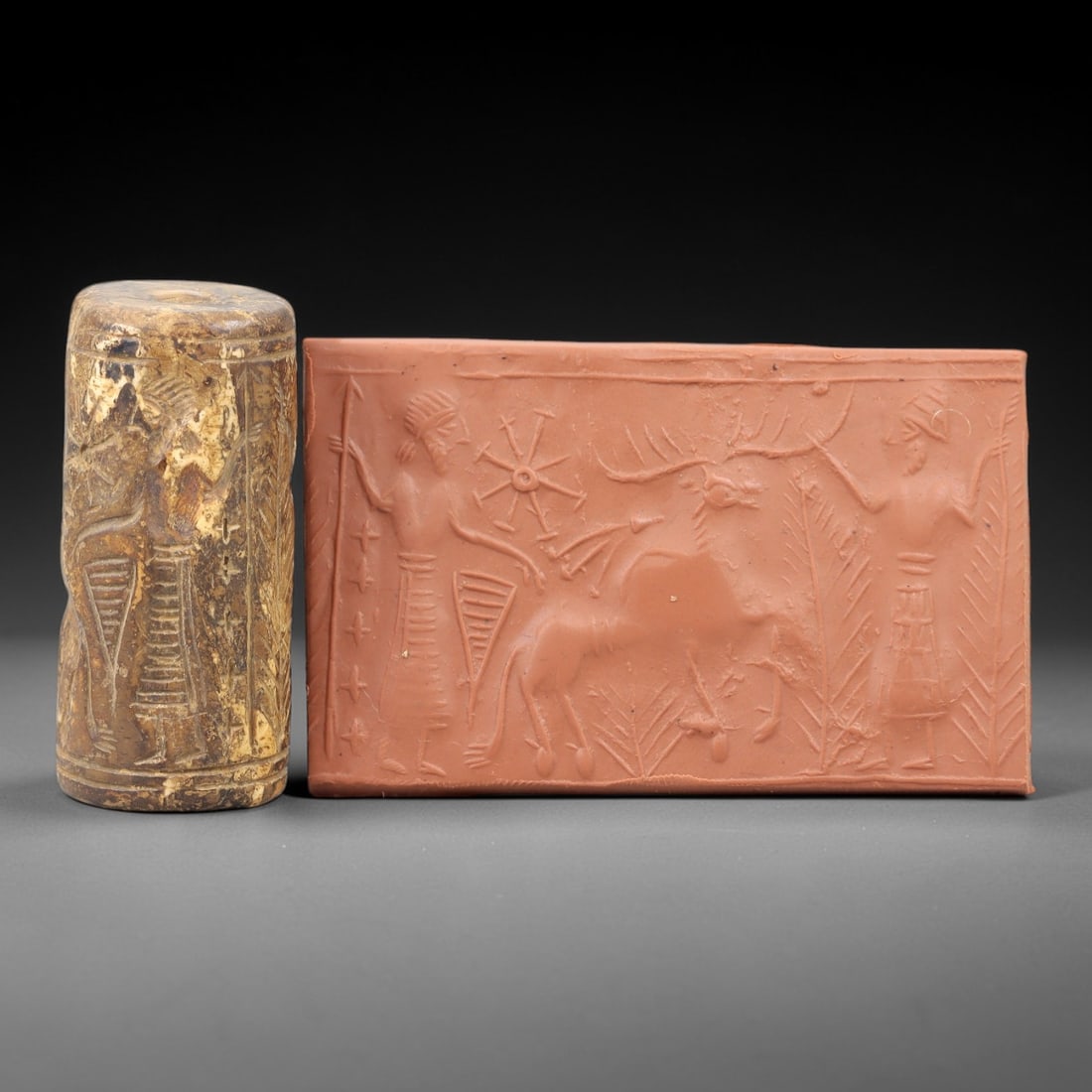 Ancient Steatite Cylinder Seal - Mesopotamian Hunting & Celestial Scene, 65AN: Carved from dense steatite, this ancient Mesopotamian cylinder seal features a dynamic linear relief composition of two human figures flanking a stag, interspersed with celestial and botanical motifs,