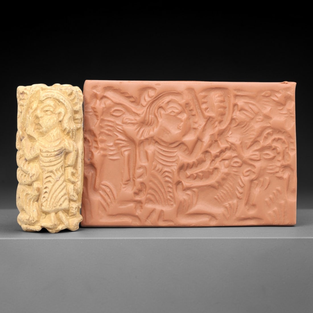 Ancient Steatite Cylinder Seal - Mesopotamian Hero & Beast, 78ZS: Crafted from smooth steatite, this ancient Mesopotamian cylinder seal bears a finely carved relief scene of a heroic figure in dynamic combat with a ferocious beast, a core iconographic motif of Mesop